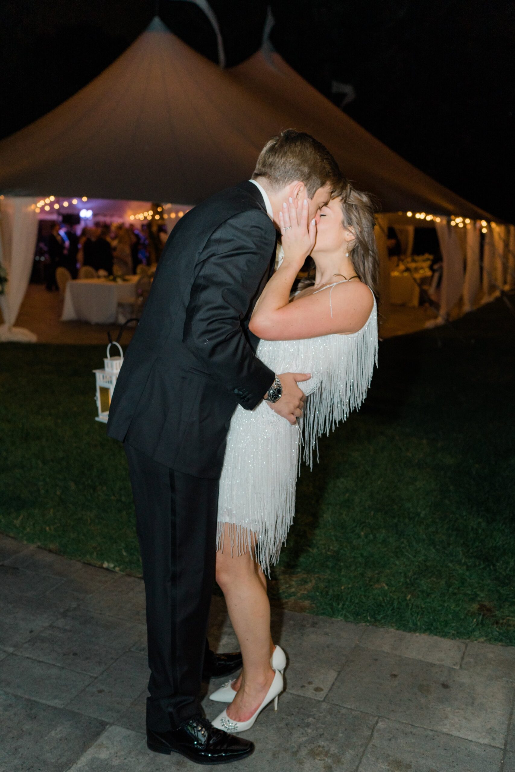 one last kiss after exiting wedding reception at Bradley Estate. Sperry tent.