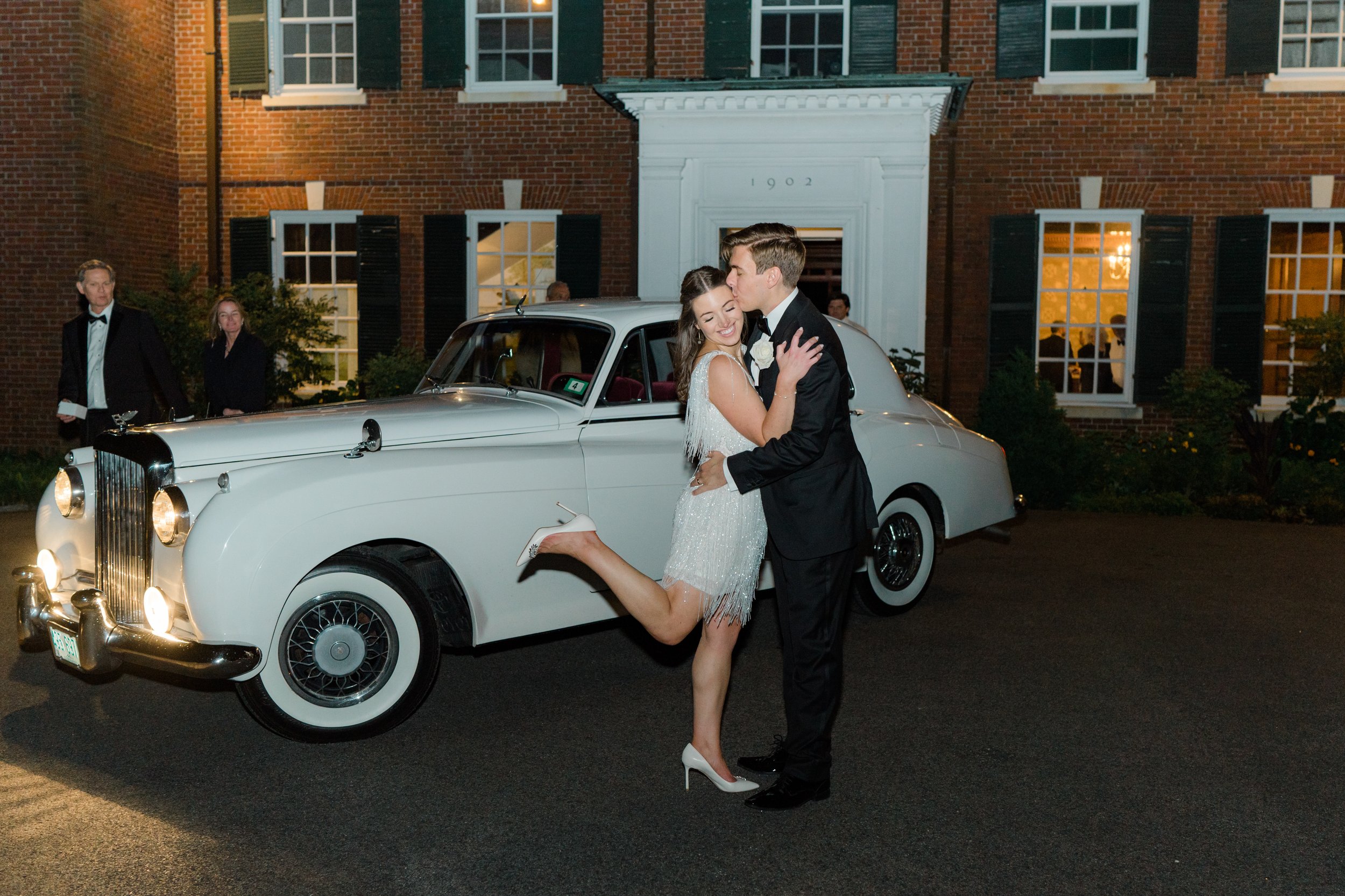 Bradley Estate getaway car with bride and groom kissing. Bride pops her foot out for one last kiss.