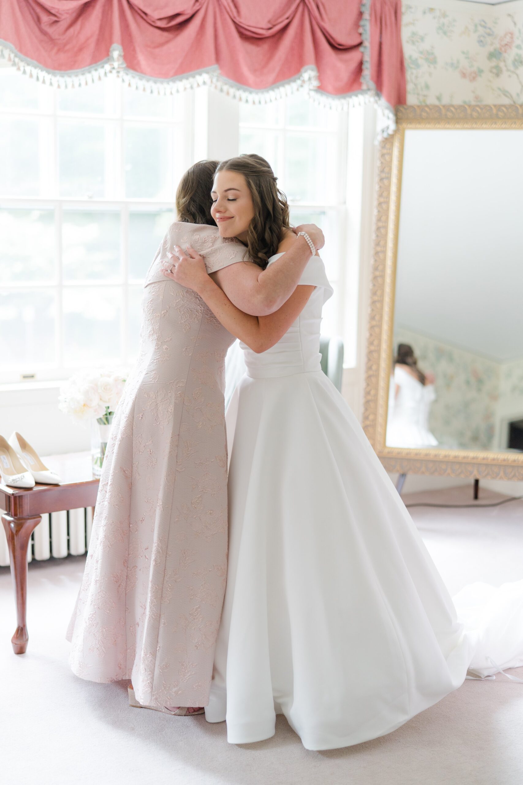 Mother of the bride shares hug with her daughter in the bridal suite at the Bradley Estate.
