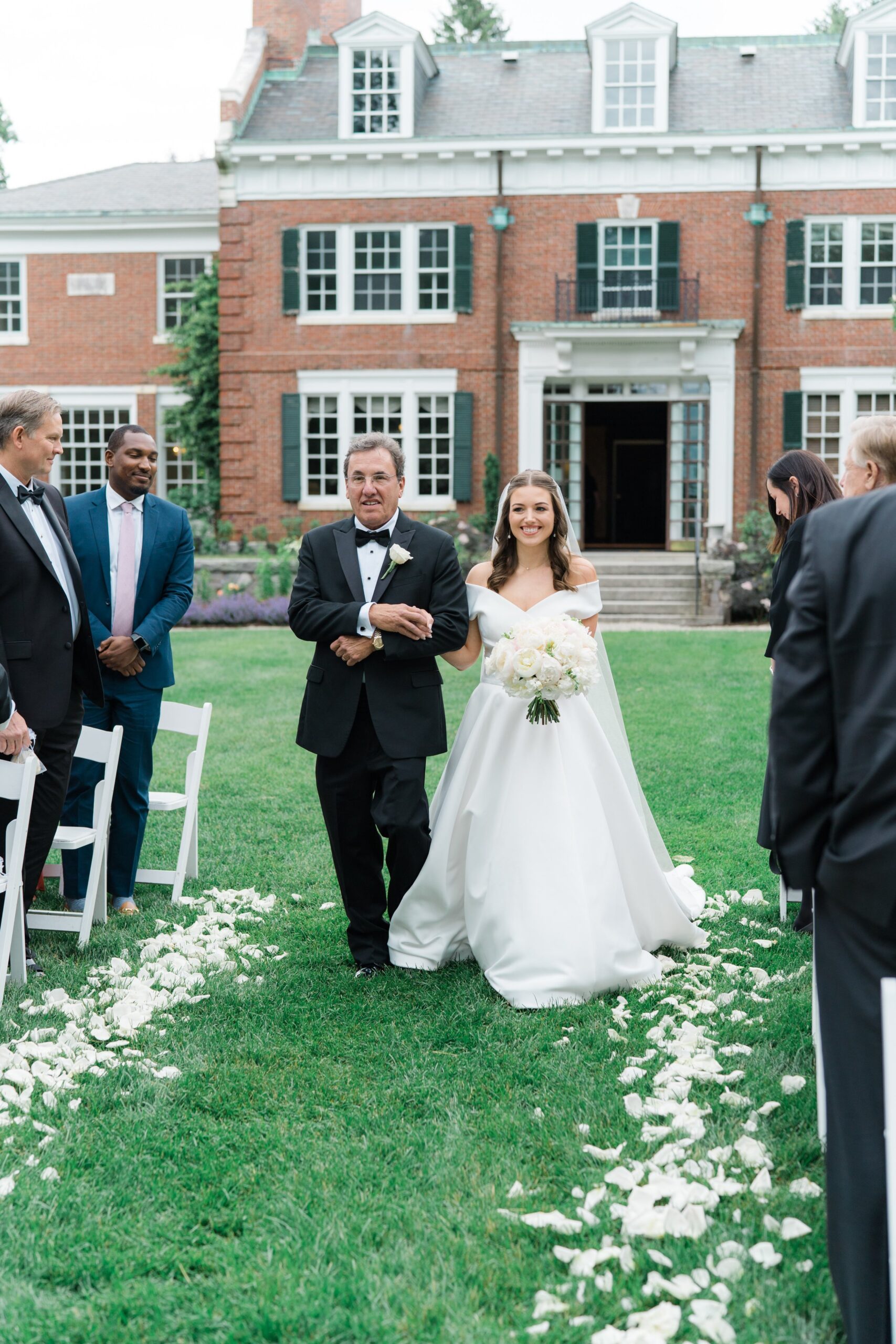 White flower petal lined wedding ceremony in the gardens at the Bradley Estate. Boston Wedding Photographer.