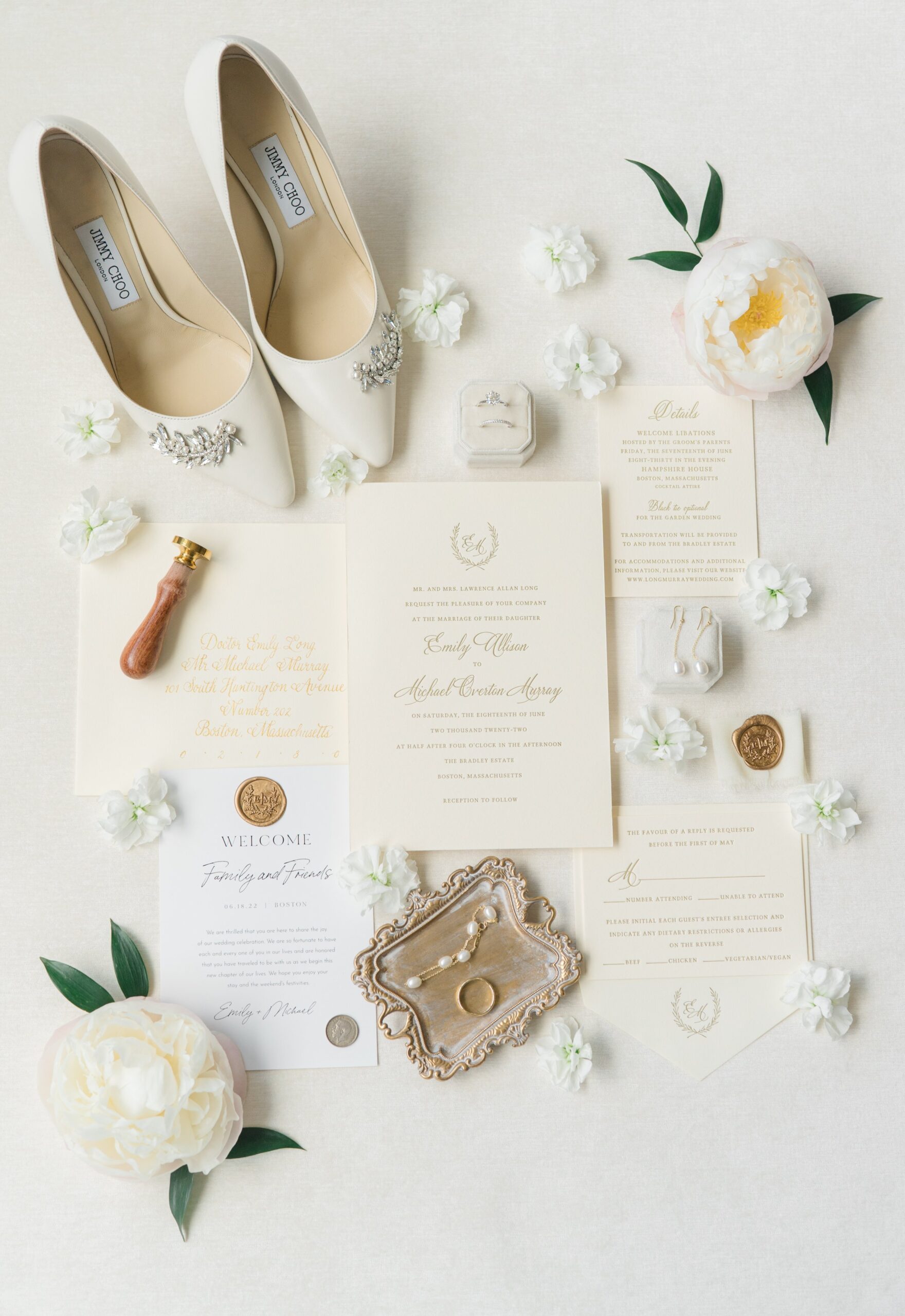 Full wedding invitation suite detail photo. Neutral tones with flowers, heels and engagement ring. Custom wax press. Getting ready at the Ritz Carlton in downtown Boston
