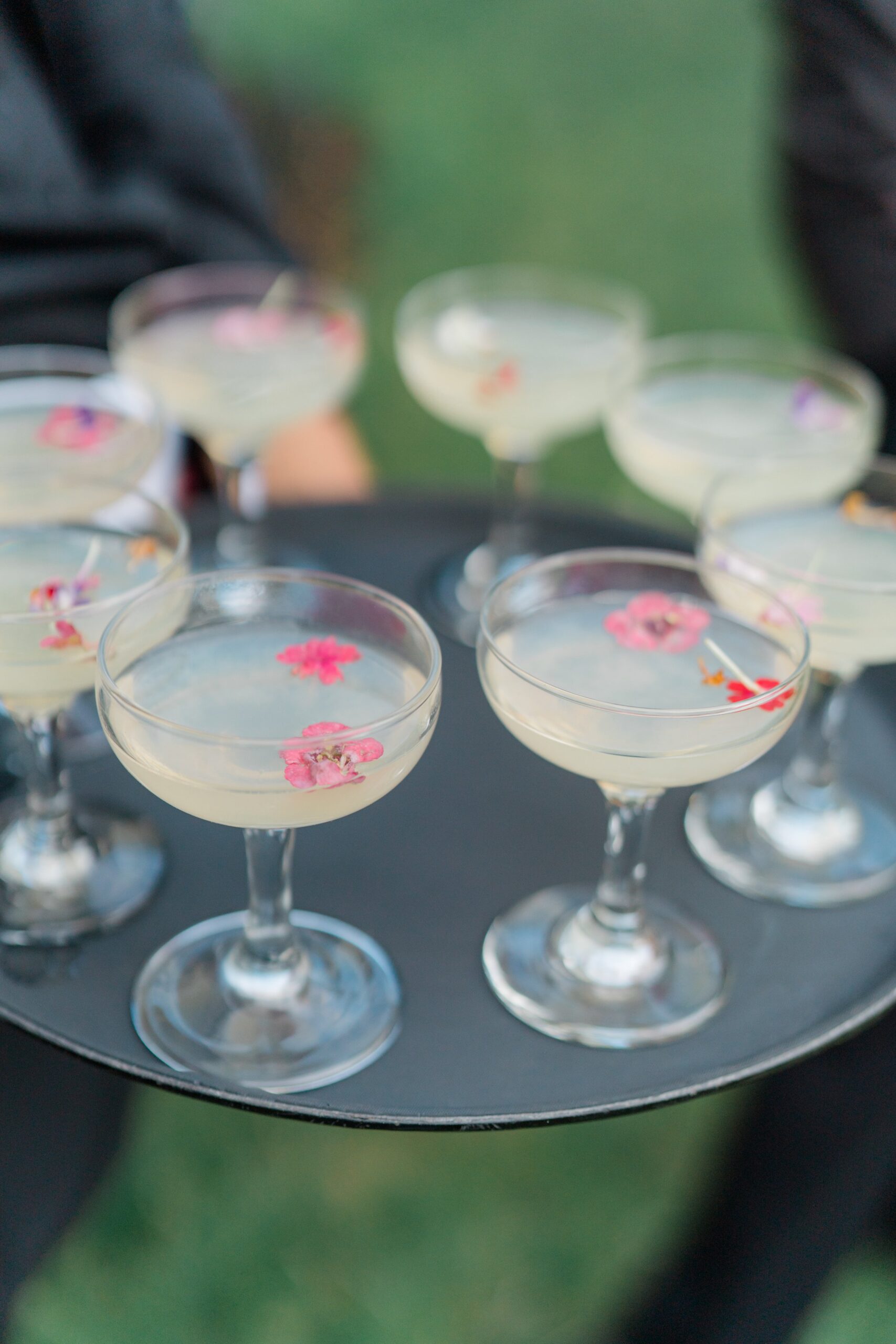Cocktails with pink edible flowers at boston outdoor wedding reception