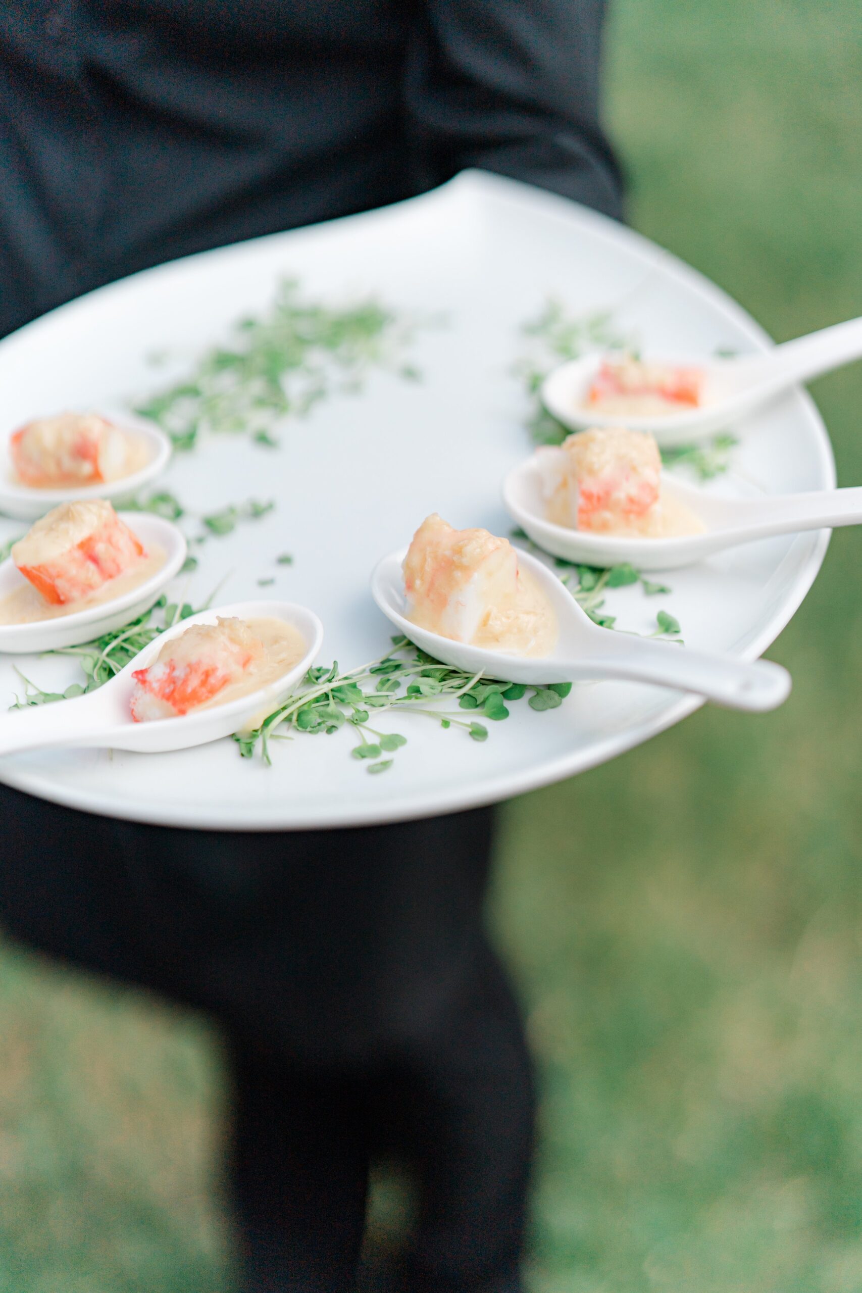 Single serving lobster bisque with big chunks of lobster at boston summer outdoor wedding reception.