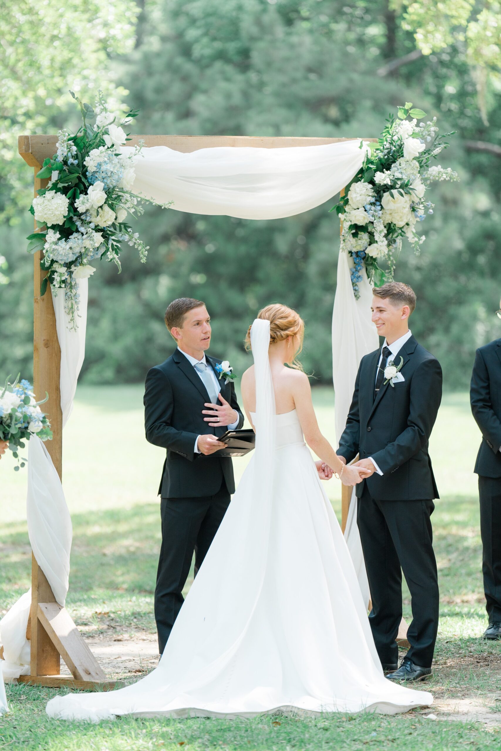 intimate moment at wedding ceremony with bride and groom holding hands