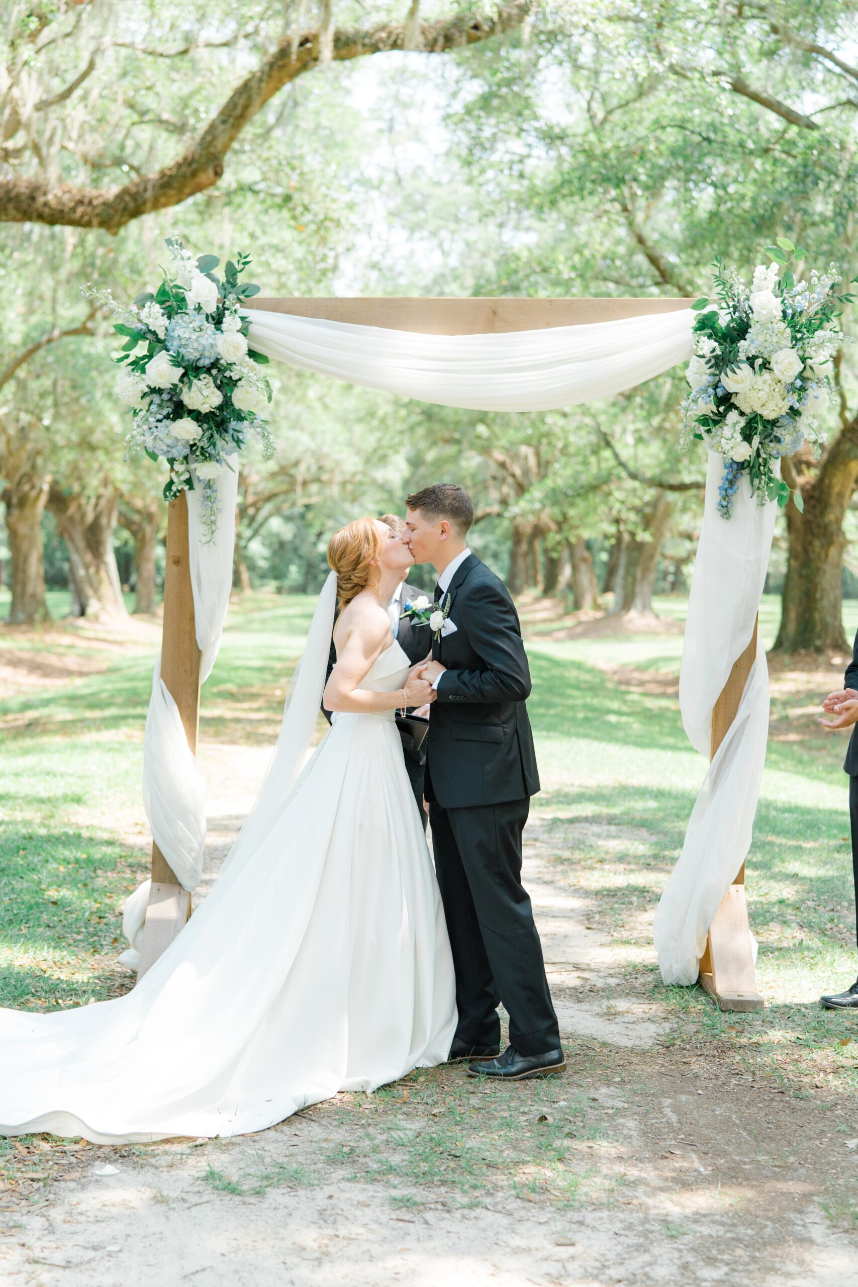 first kiss at Charleston spring outdoor wedding ceremony.