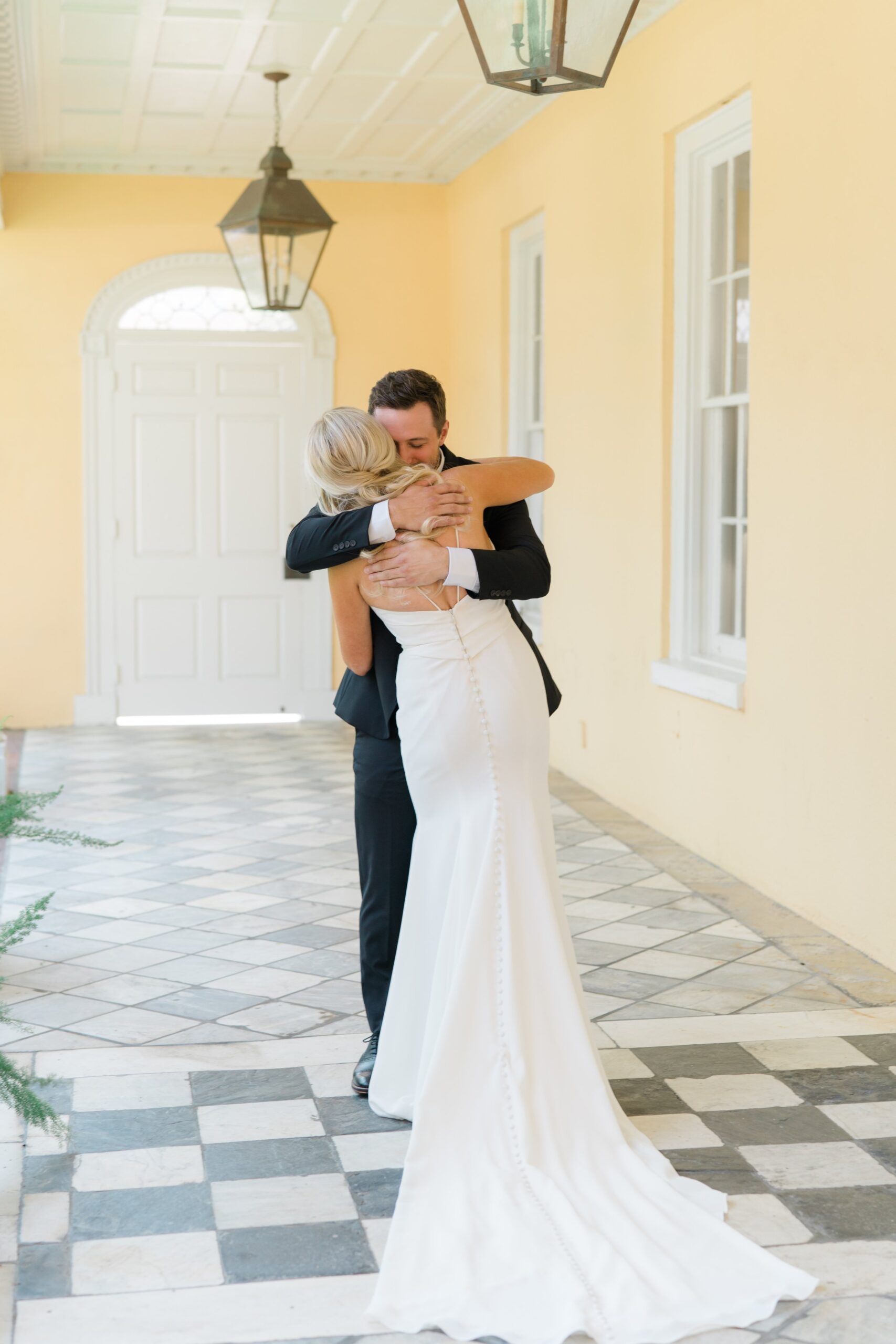 bride and groom share a hug after seeing each other for the first time on wedding day.