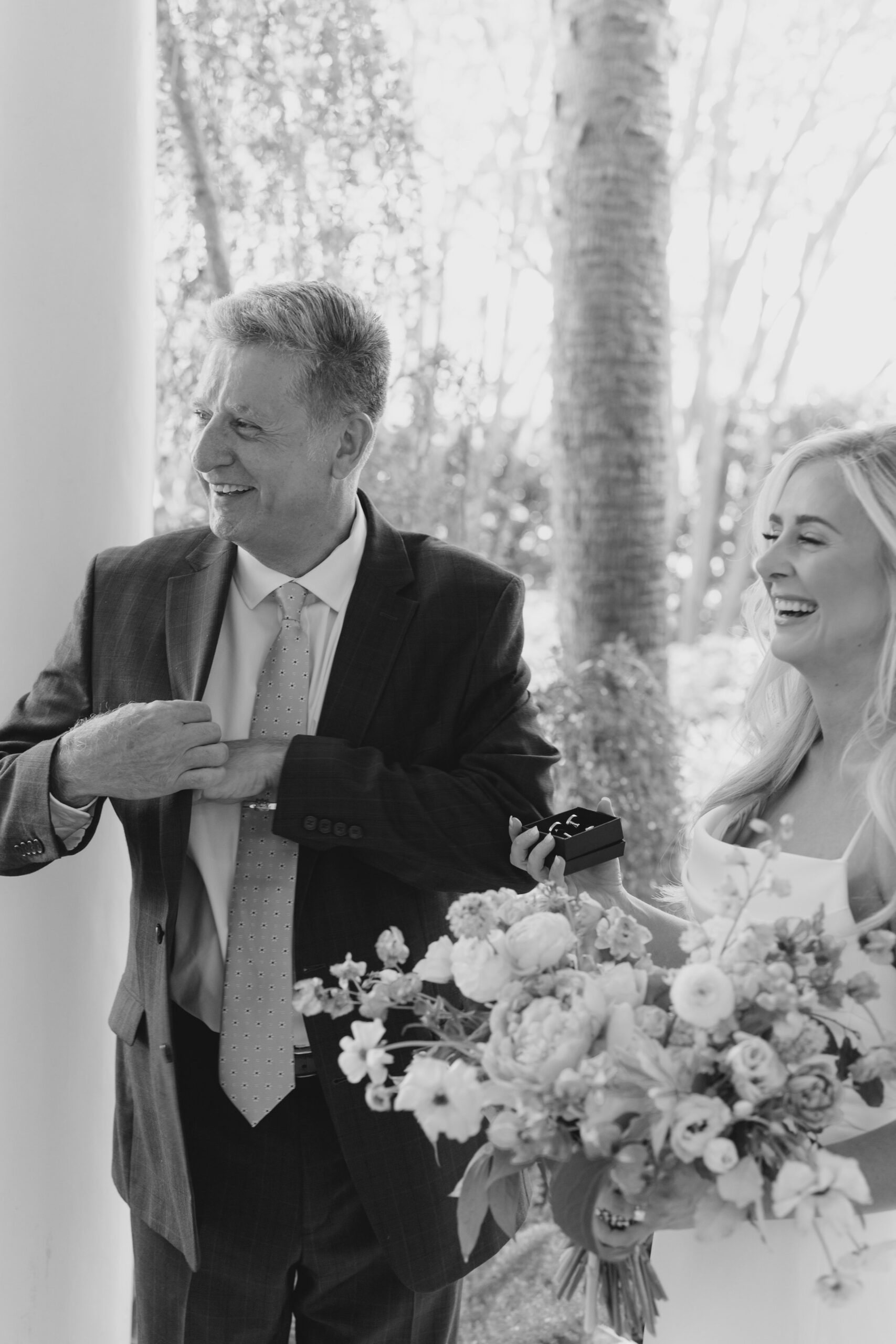 black and white wedding dad photo. father of the bride shares a moment with his daughter.