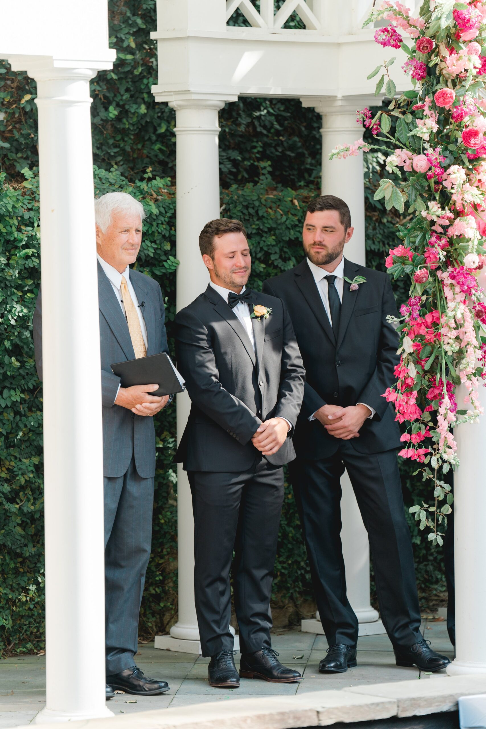 emotional groom with best man support at spring charleston wedding ceremony.