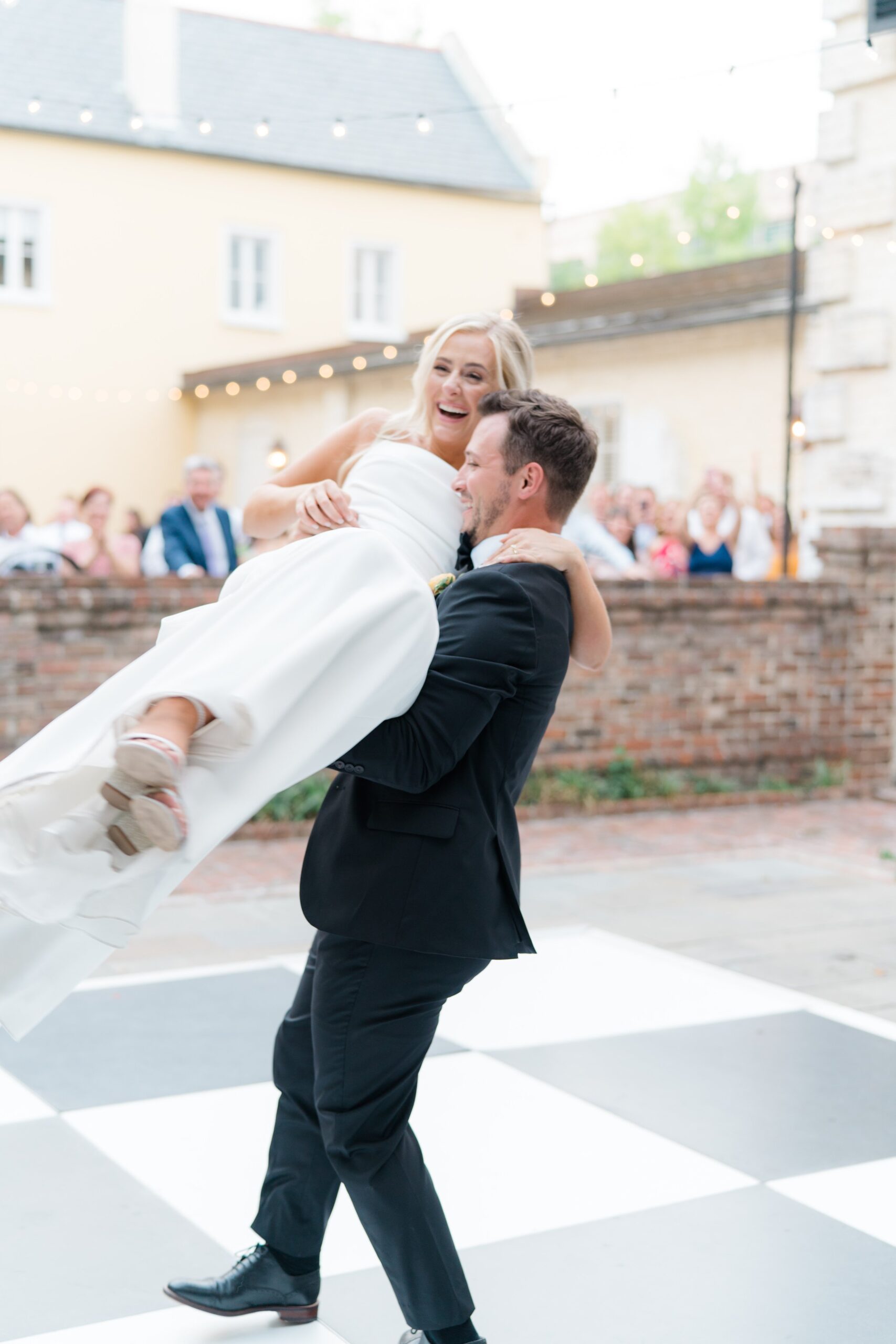 groom picks up bride during first dance and spins around.