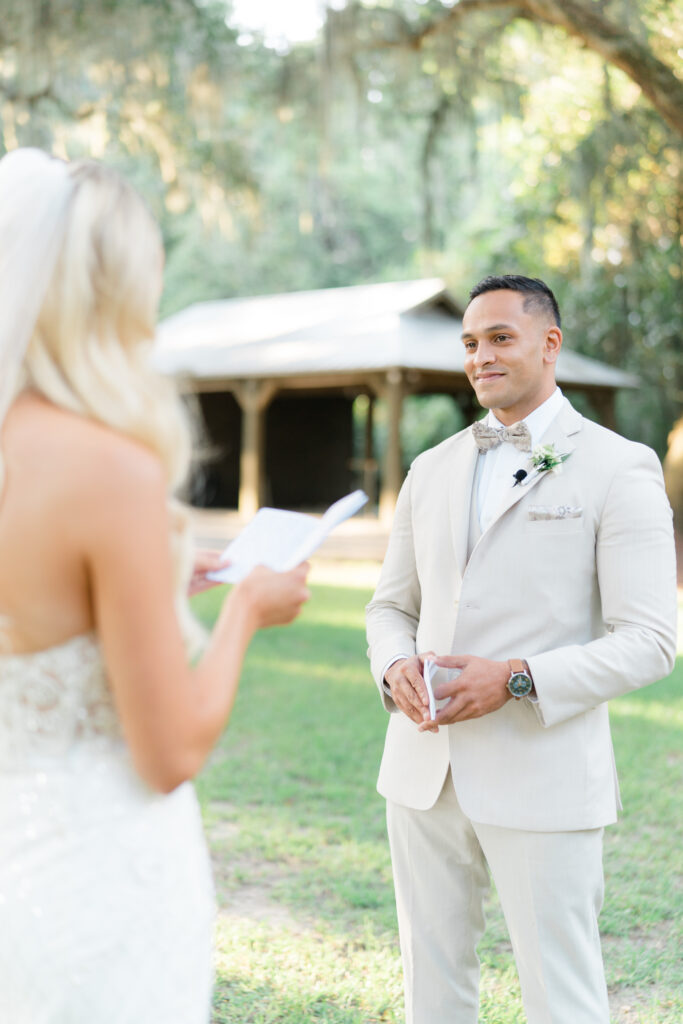 Groom in tan 3 piece suit and patterned bow tie. Private vow reading before intimate fall ceremony in Charleston. 