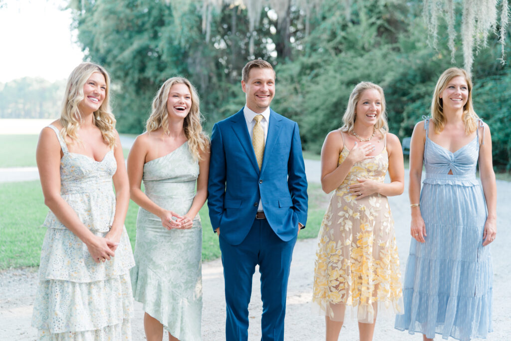 Bride's five siblings have a private first look with her. Soft pastel dress code. 