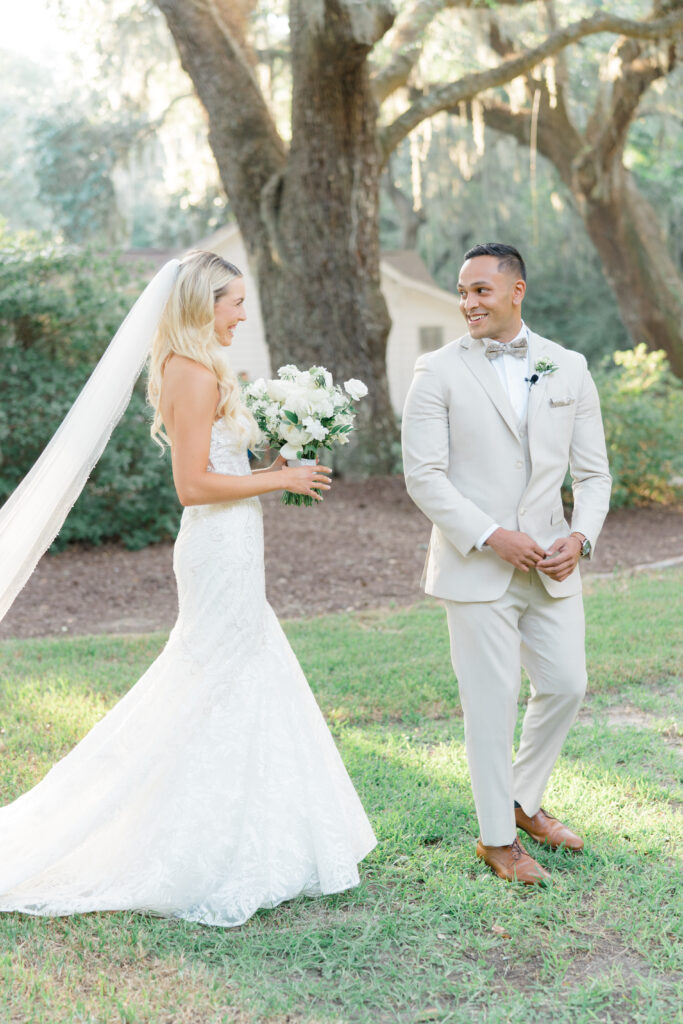 Groom turns around to see bride for the first time. Intimate fall wedding in Charleston. Groom in tan suit and bow tie. 