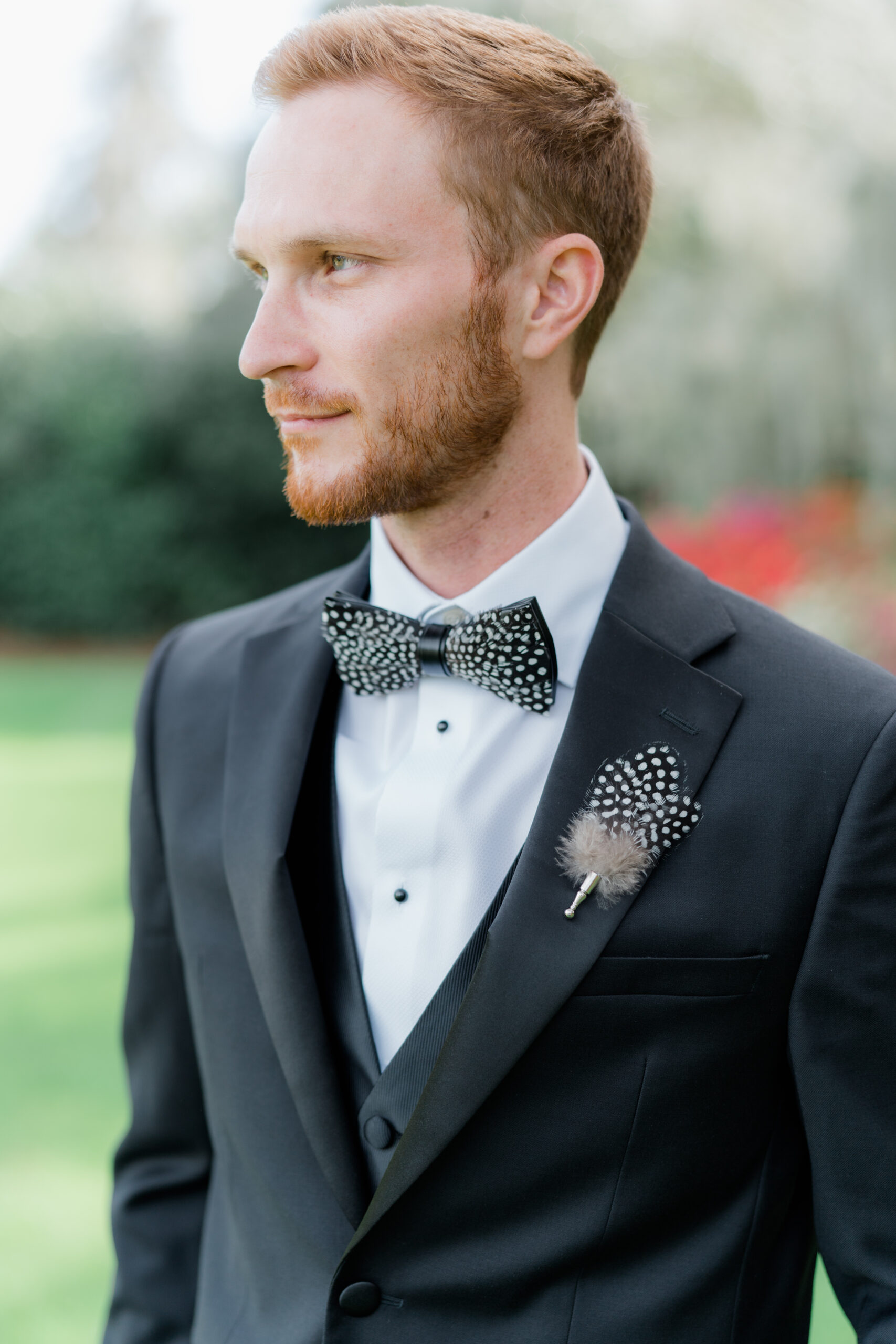 Brackish bowtie and lapel pin. Red-head groom in black tuxedo. 