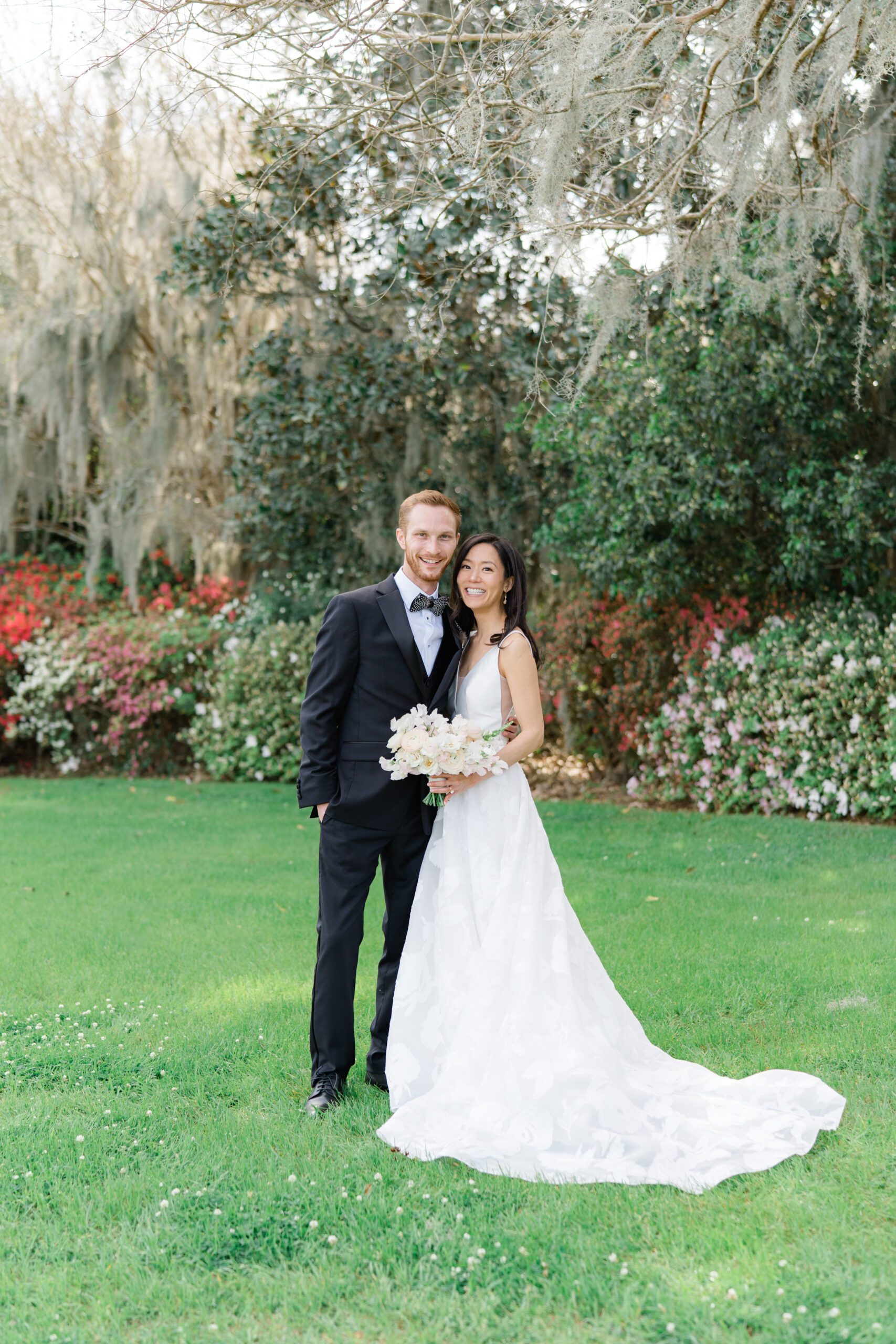 Bride and groom portraits at Middleton Place with greenery and spanish moss. Charleston azalea blooms. 