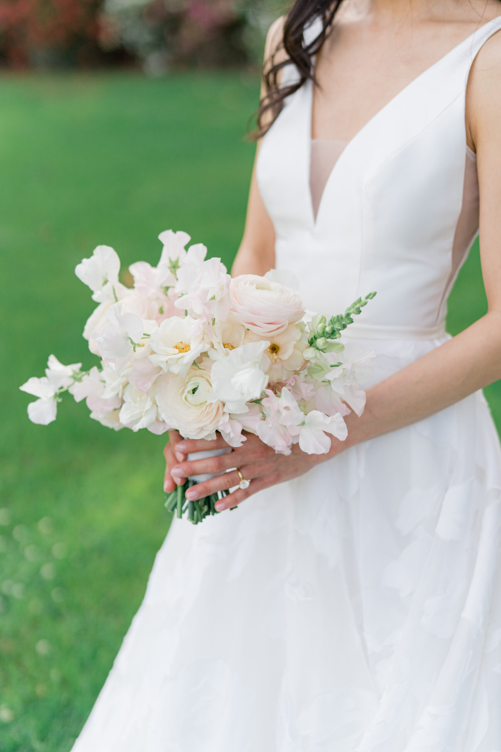 Bride holding her bouquet. Small bride flowers that match her proportions. 