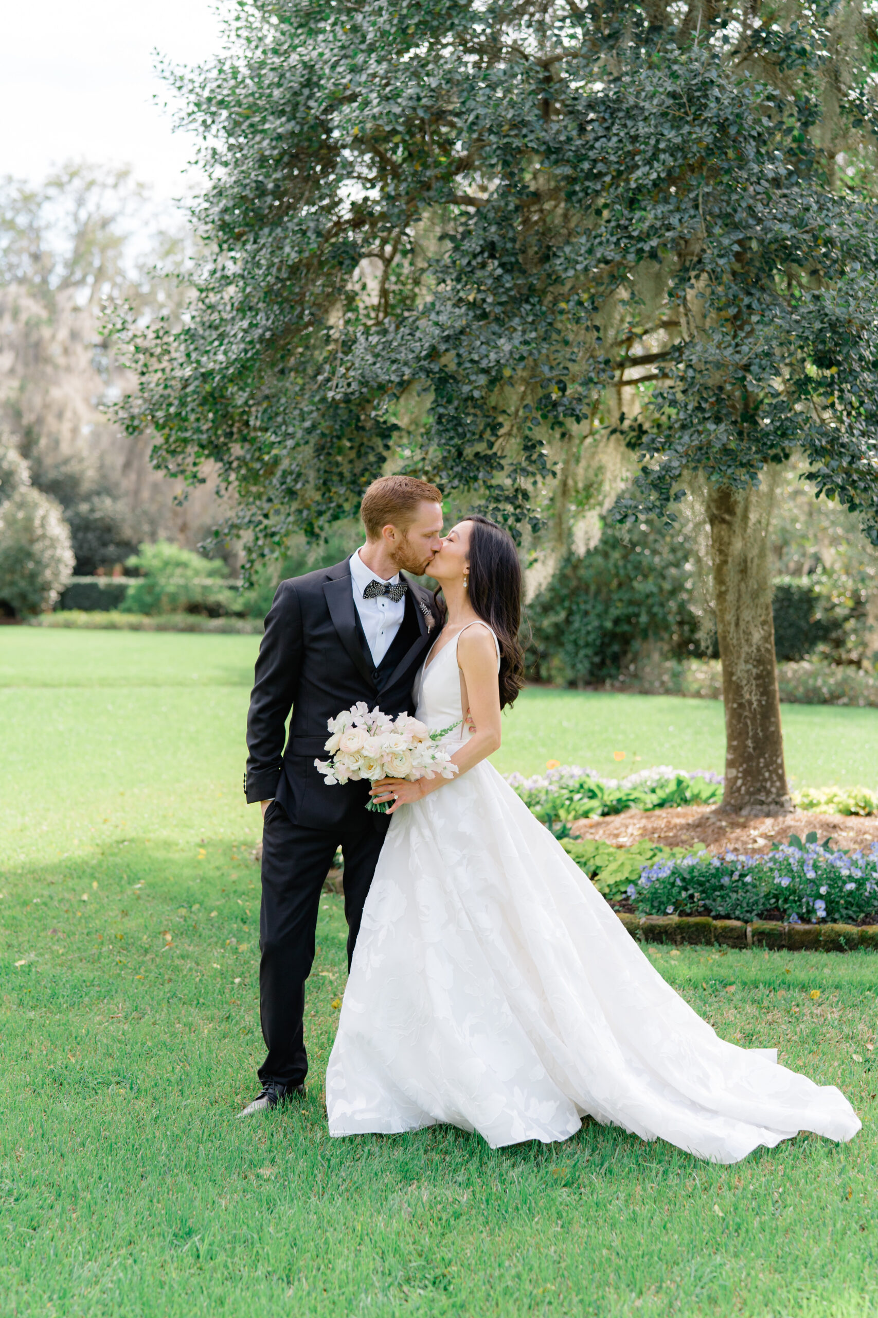 Bride and groom kiss in the secret garden at Middleton Place. 