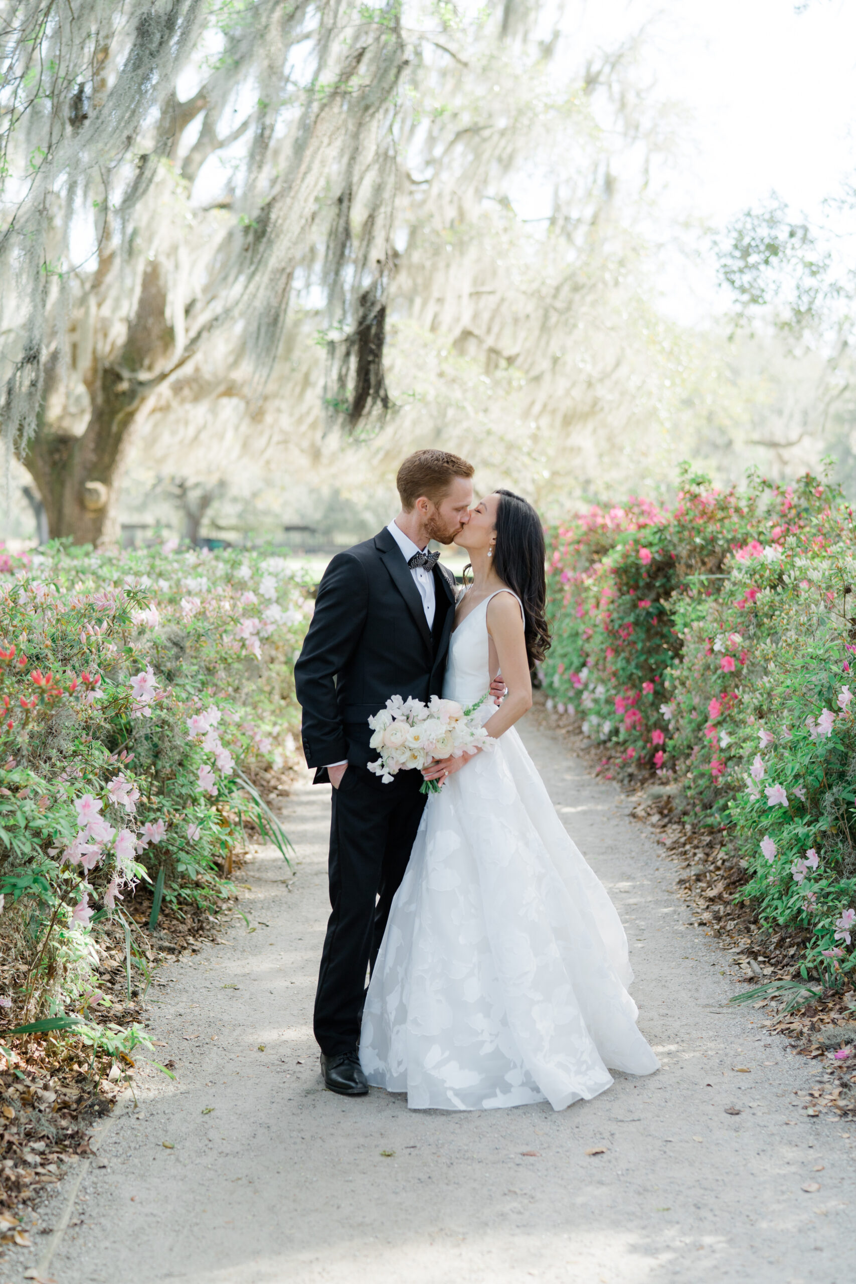 Bride and groom portraits at Middleton Place with azalea bushes blooming.