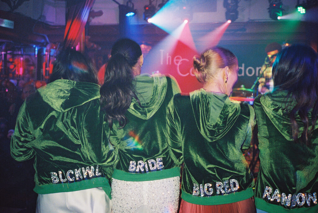 Bridesmaids bring matching jackets from bachelorette party to the wedding after party at the Commodore. Wedding after parties in Charleston, SC.