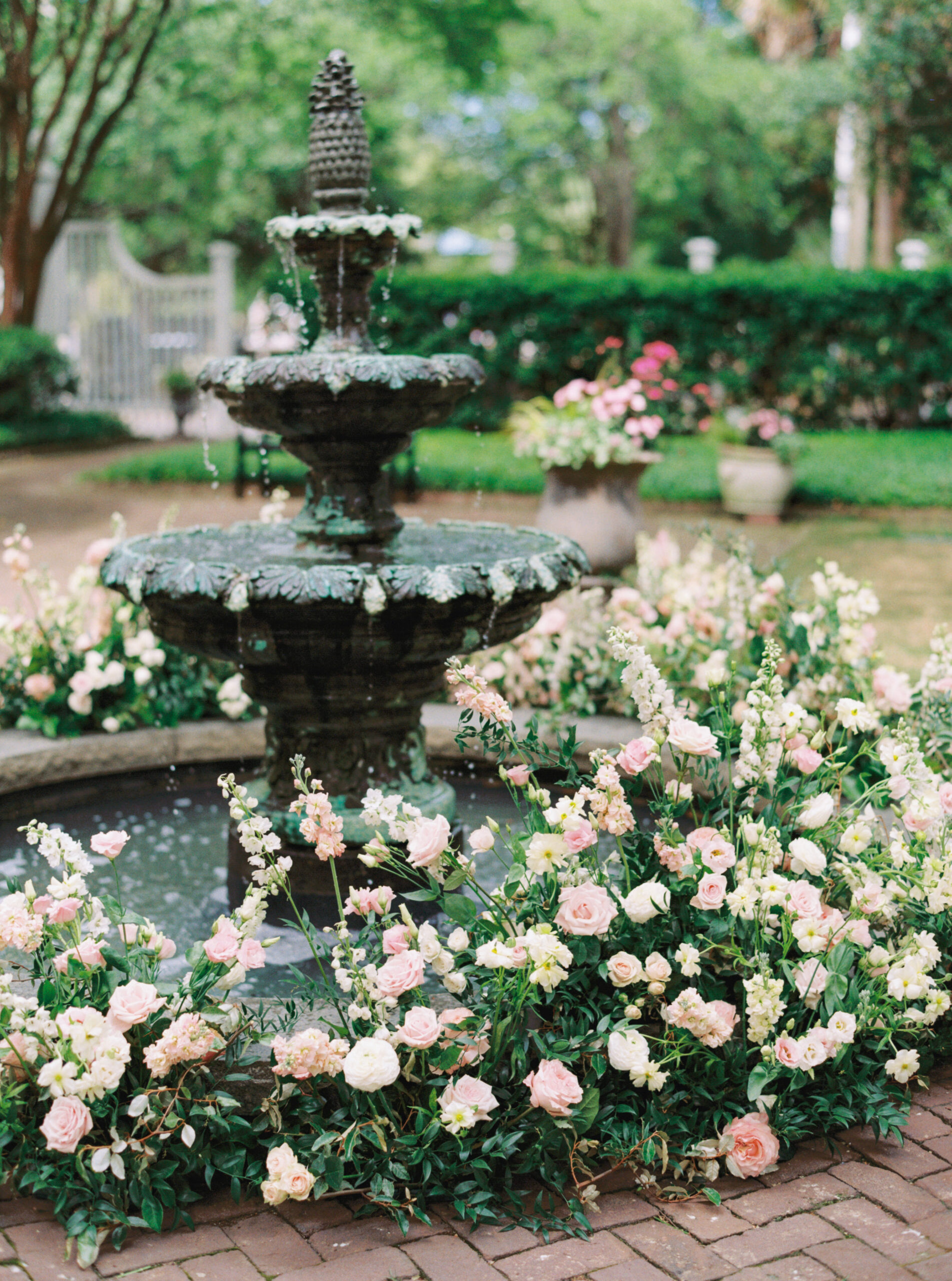 Pineapple fountain decorated with white and pink wedding flowers. 