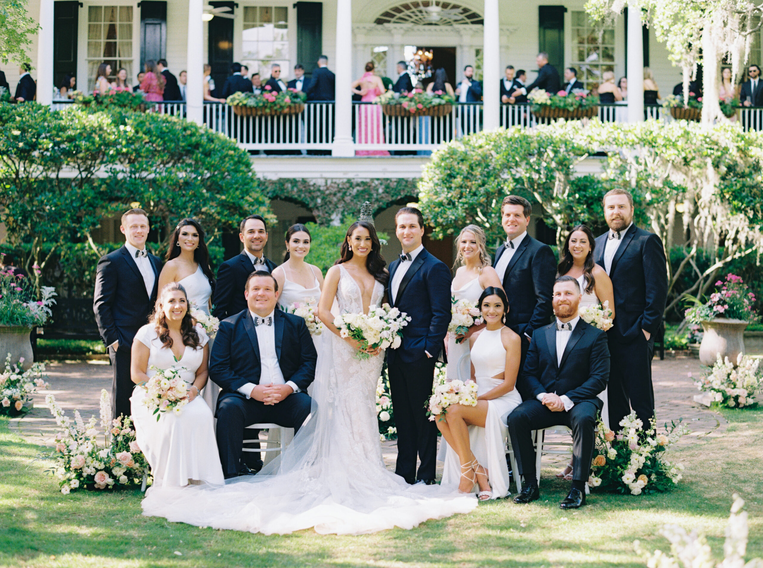Bridal party portrait in front of cocktail hour on the porch at Thomas Bennett House.