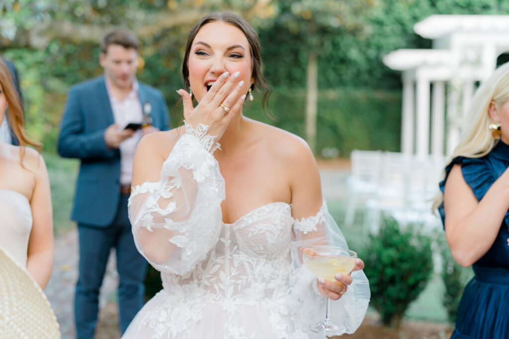 Bride laughs with her friends during cocktail hour. 