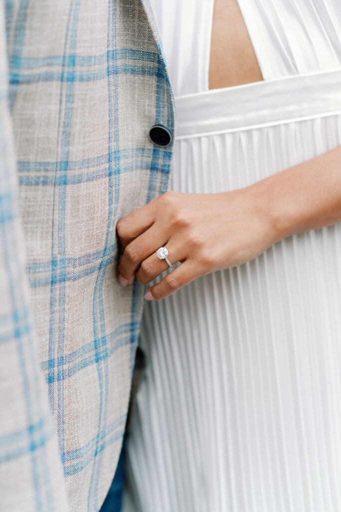 engagement ring detail photo. Bride holding grooms jacket. 