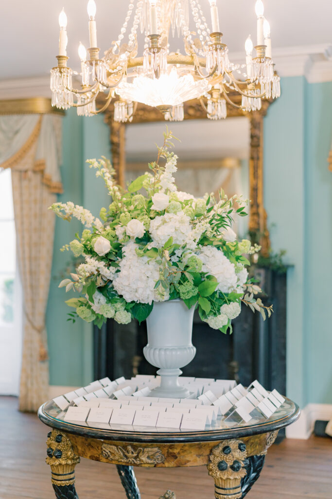 Pedestal flowers and place card table. Charleston photographer wedding.
