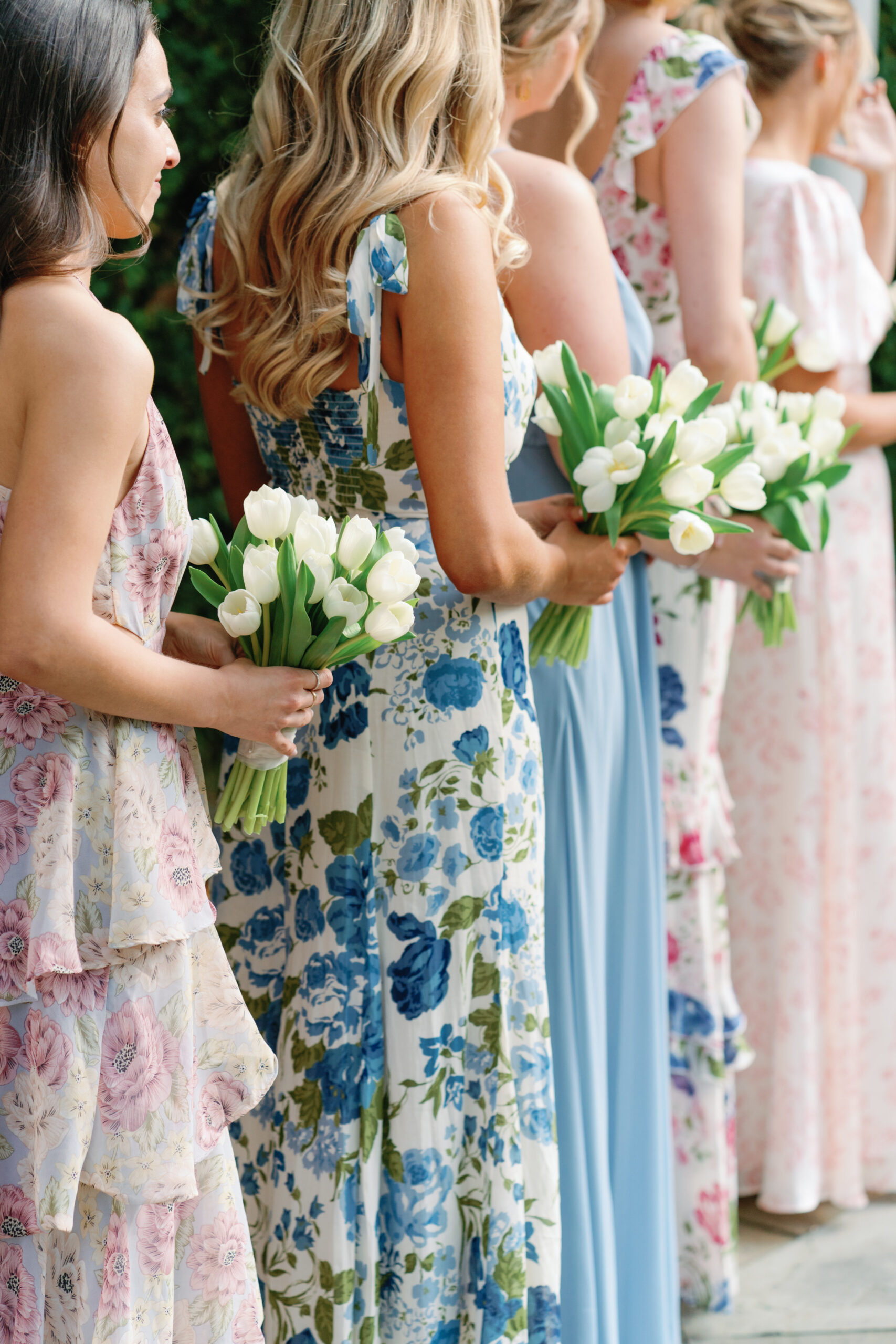 Bridesmaids at the wedding ceremony. White tulip bouquets.