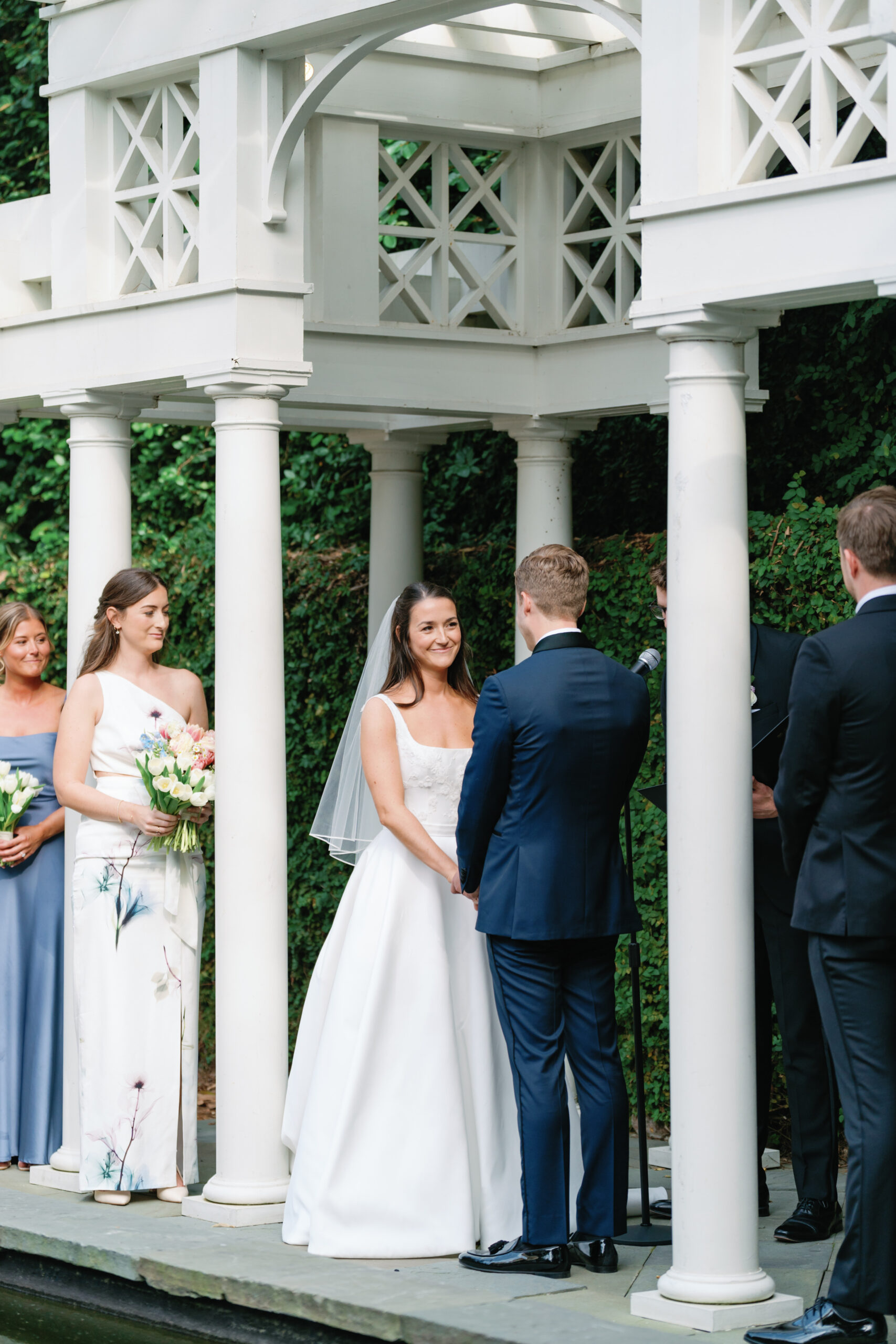 Bride smiles at groom during wedding ceremony. Wedding photographers in Charleston 