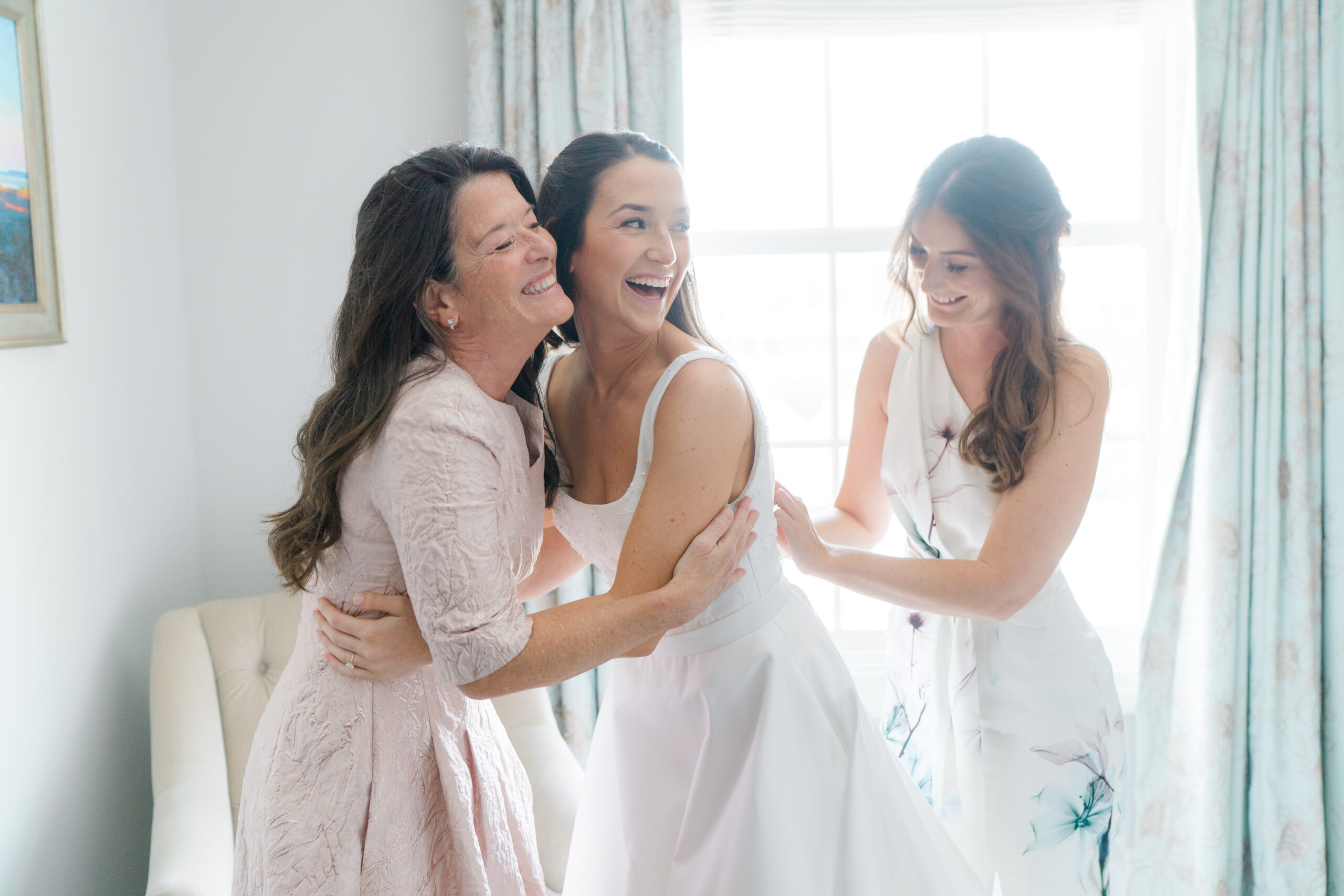 Mother of the bride with daughter and sister.