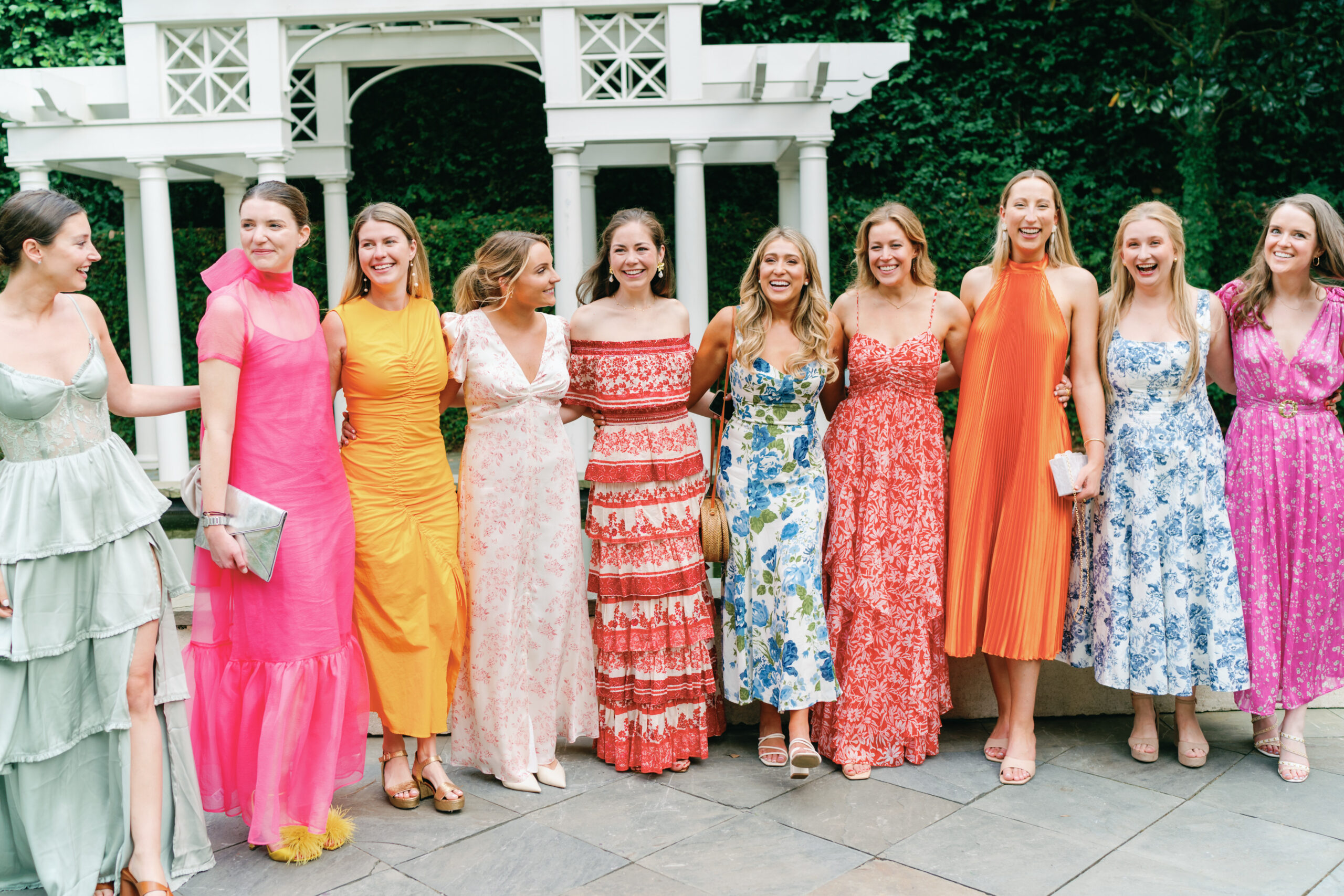 The girls gather for a big group photo at William Aiken House spring wedding. Garden party dress code. 