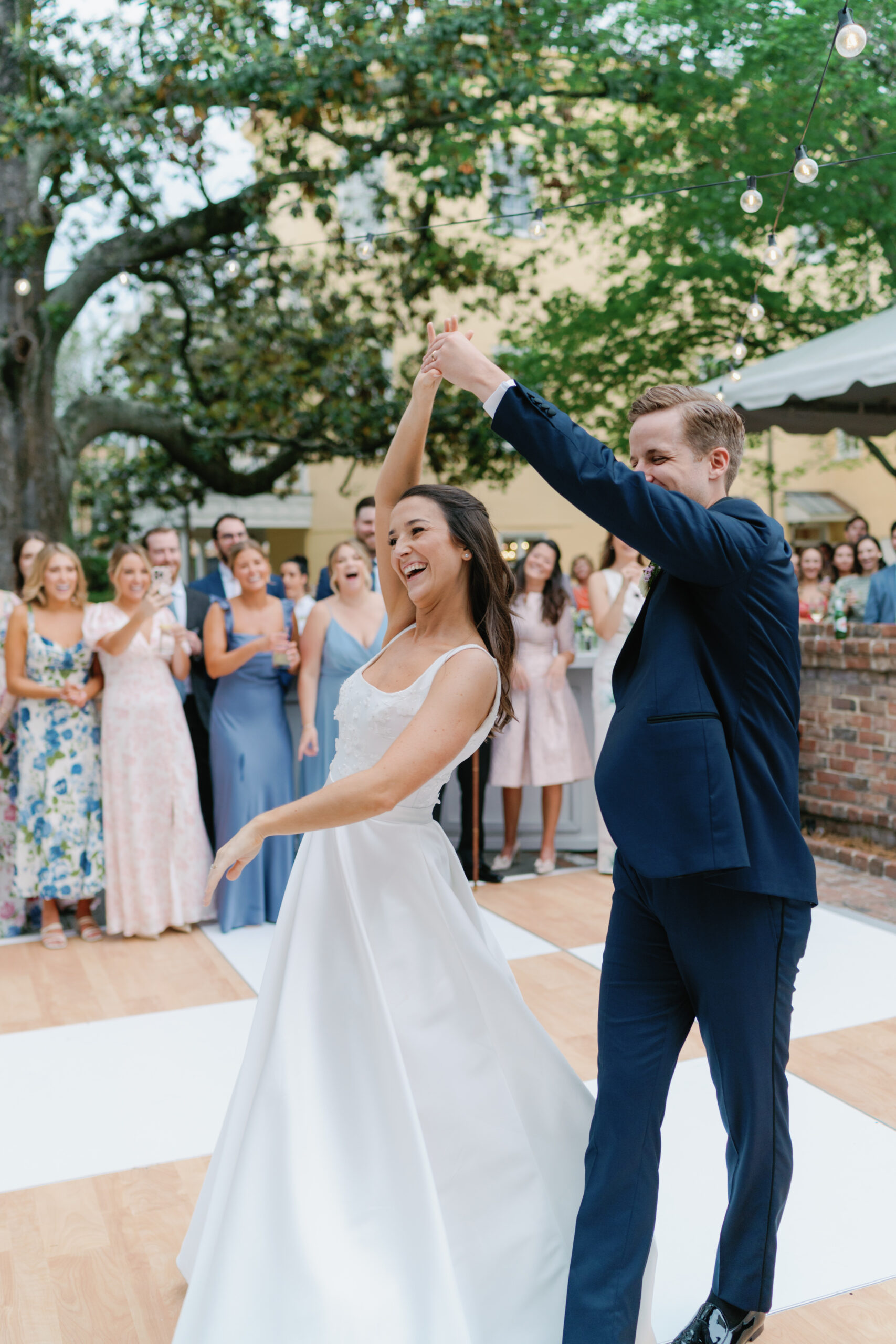 First dance spin. Groom spins the bride during first dance at William Aiken House wedding. Photographers charleston