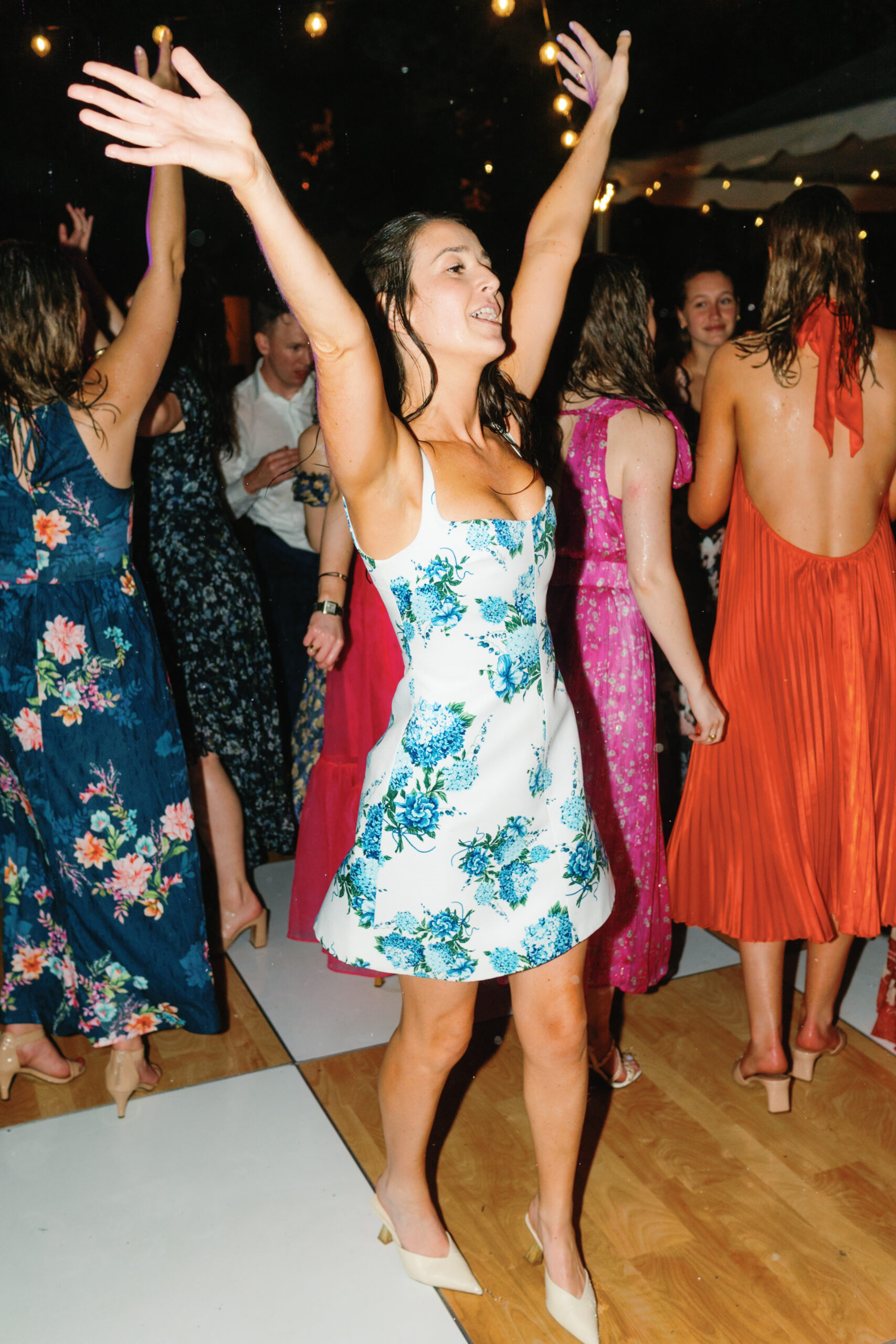 Bride changes her dress and hits the dance floor in the rain. 