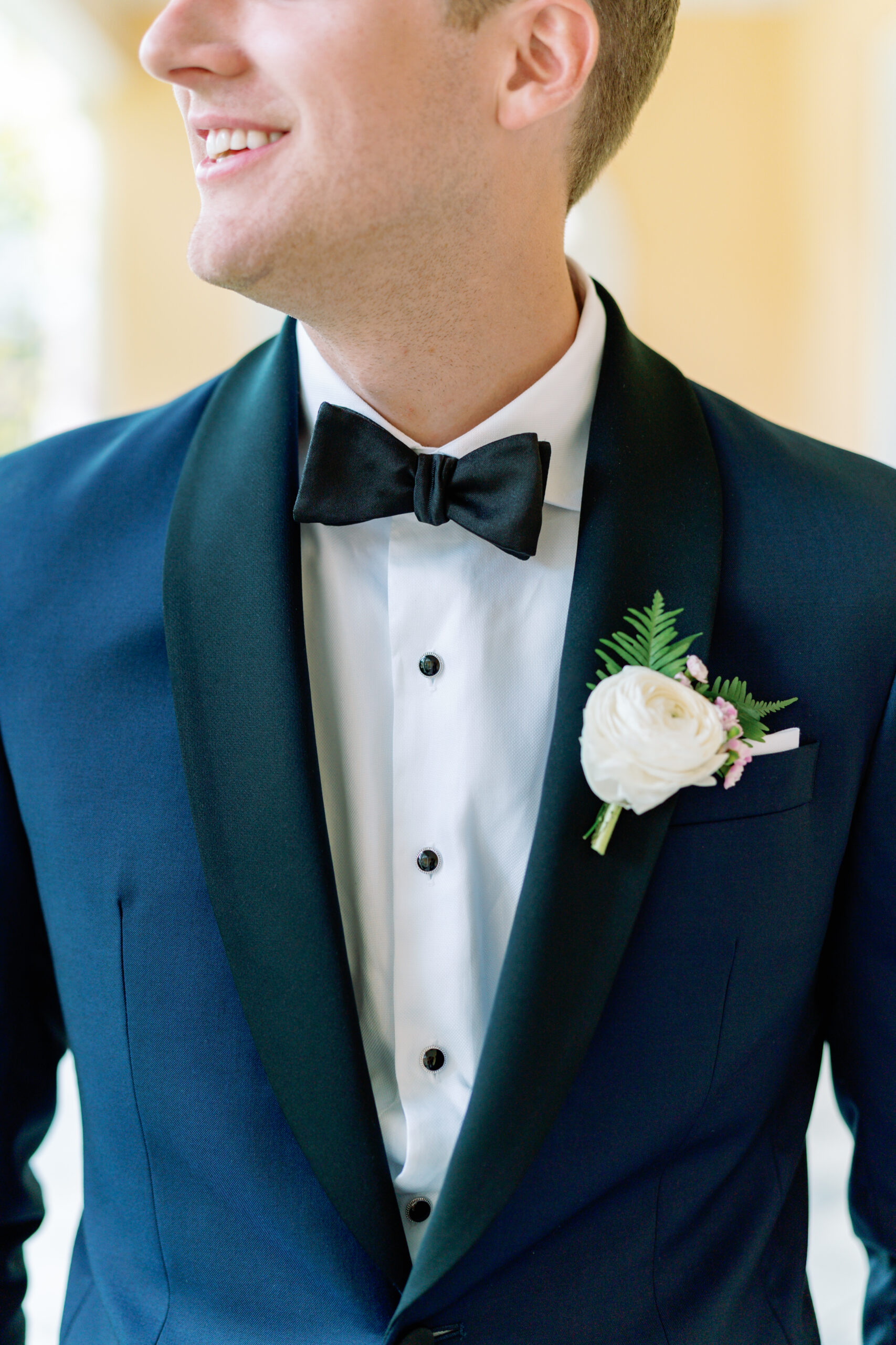 Charleston groom in dark blue tuxedo and white boutonniere 