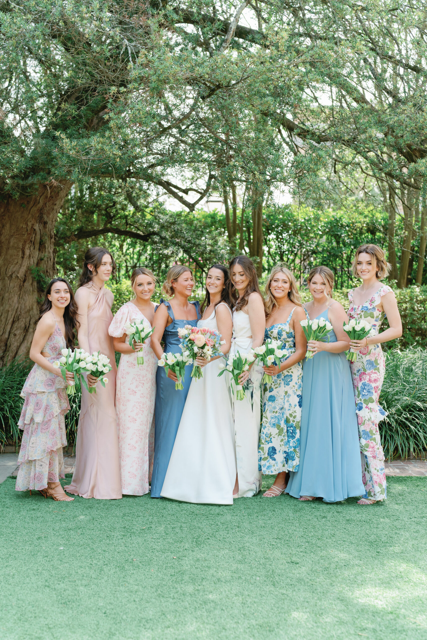 Bride laughing with bridesmaids in the garden at William Aiken House. 