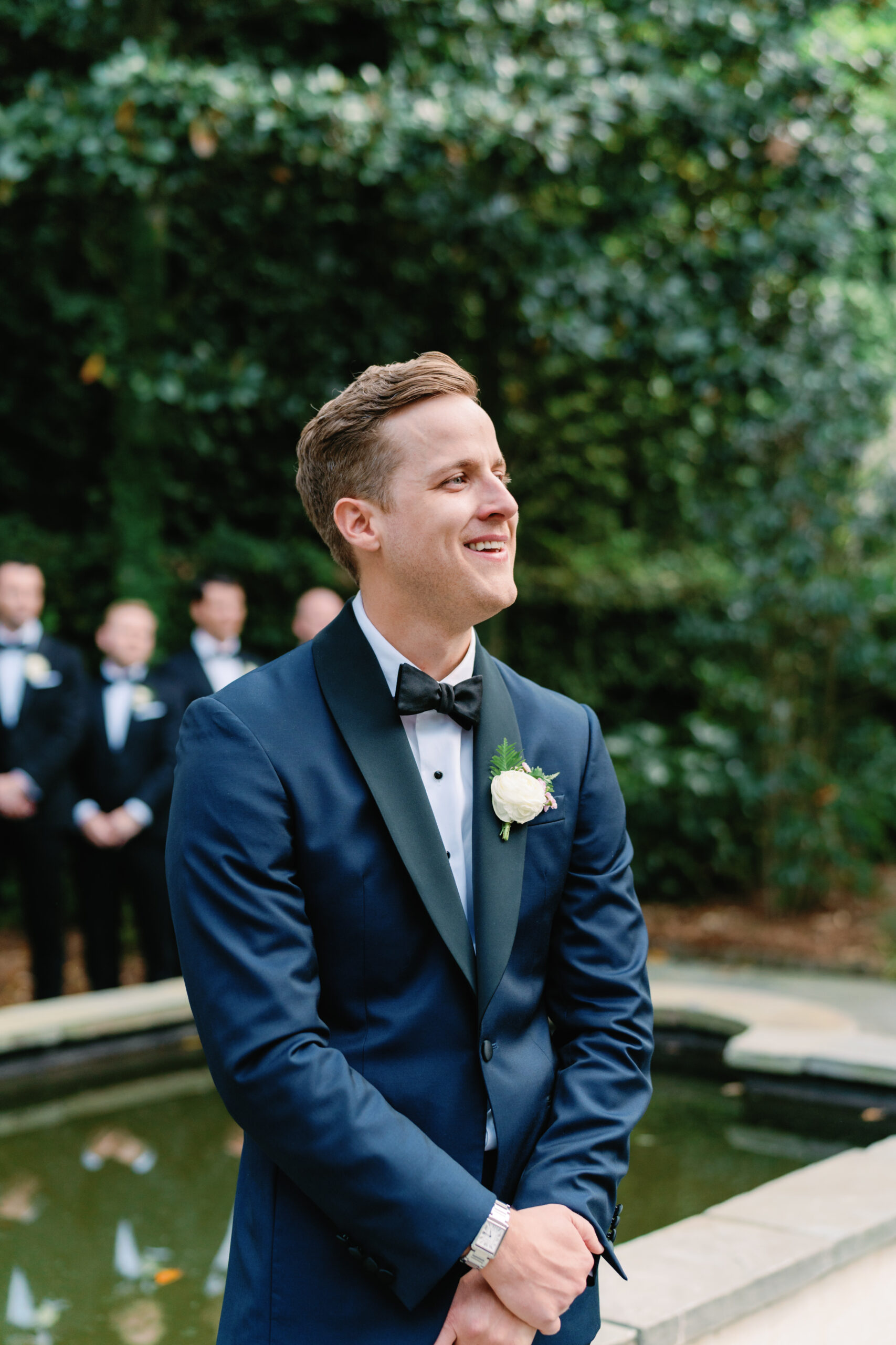 Groom sees bride at wedding ceremony. Blue tuxedo.