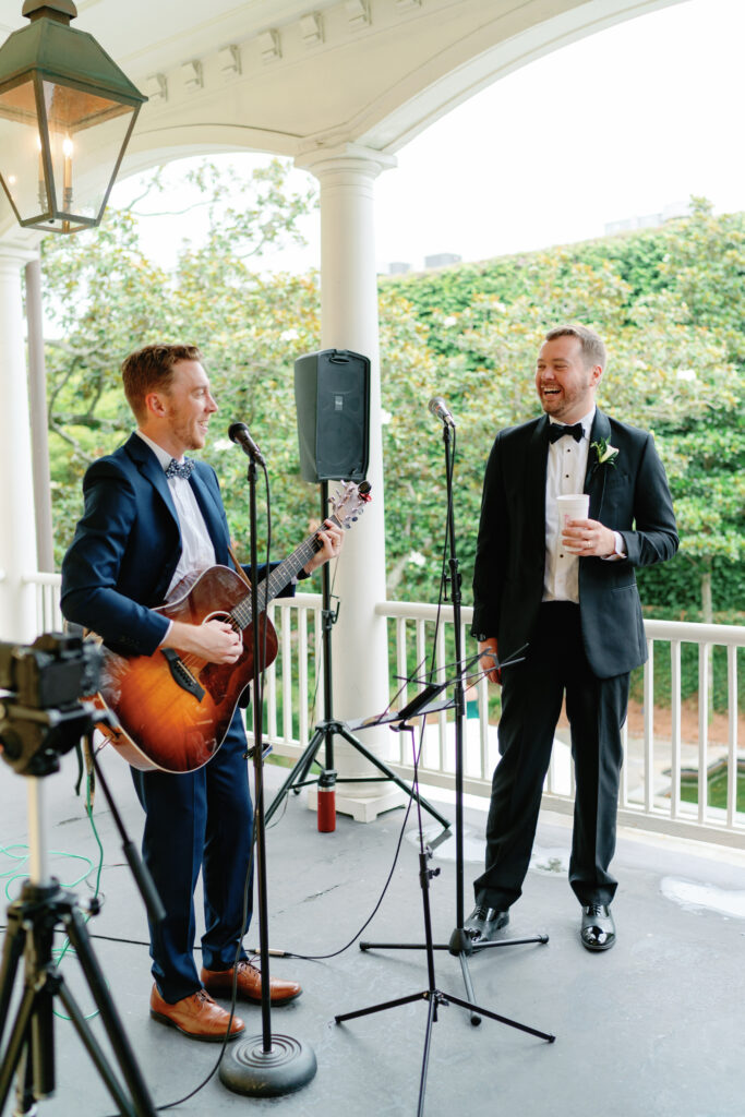 Bride and groom's friend sang with his guitar for live music at cocktail hour on the porch at William Aiken House. 