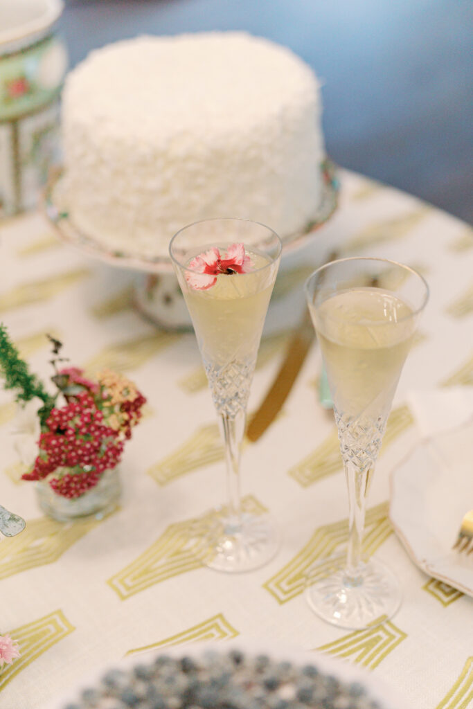 Bride and groom champagne flutes with edible flowers. 
