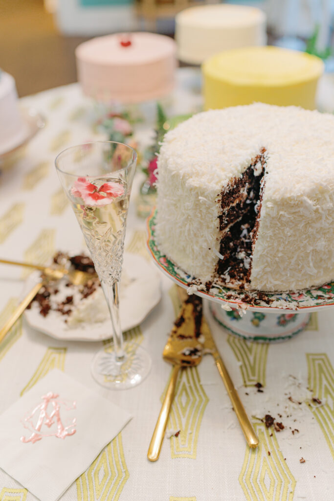 Picture of coconut wedding cake slice cut out with champagne glass. 