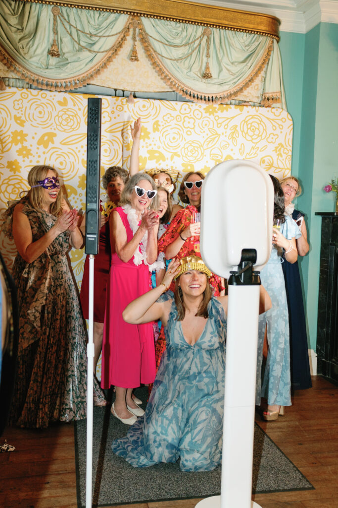 Wedding guests using photo booth.