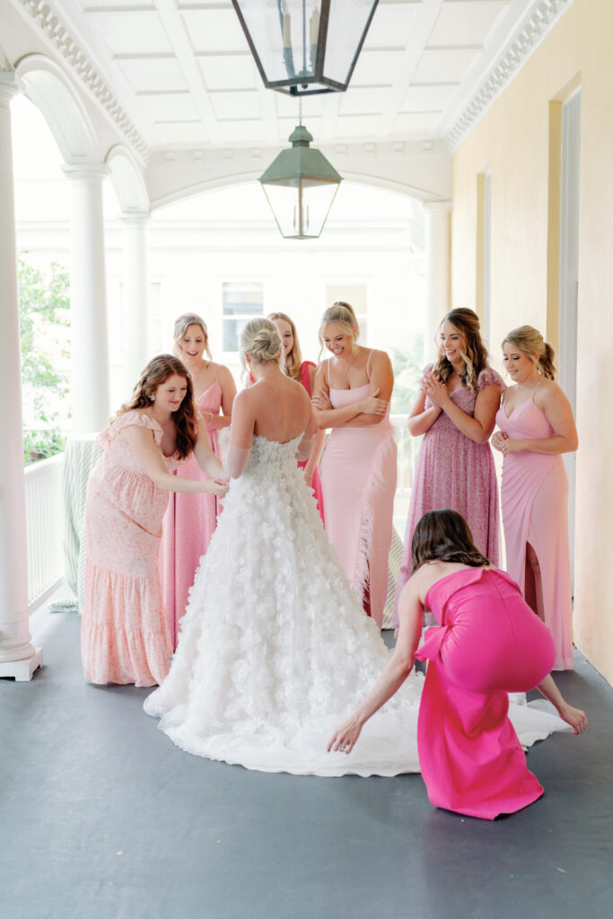 Bridesmaids see bride's wedding dress for the first time on wedding day. charleston sc wedding photography. 