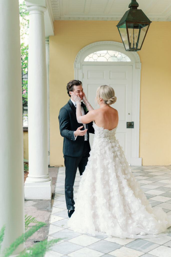 Bride wipes away groom's tears during first look. Charleston wedding photography