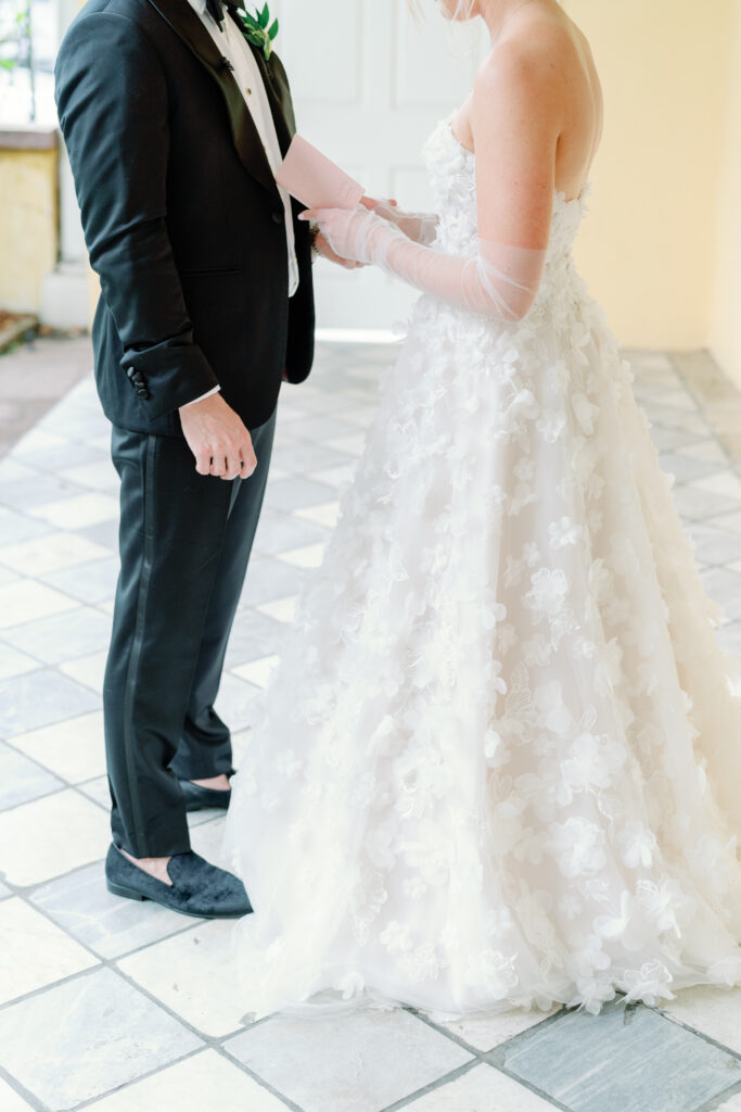Groom holding bride's hand during private vow reading. Charleston sc wedding photography