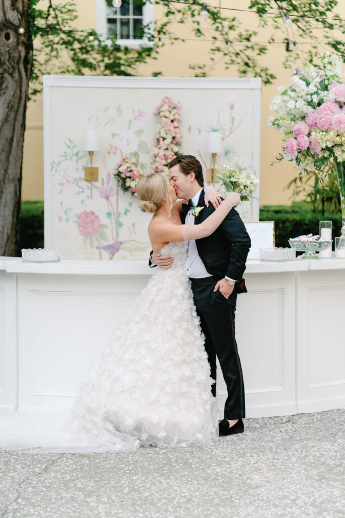 Bride and groom kiss at wedding reception. photographer charleston. 
