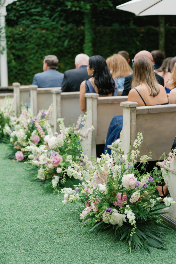 Guests find their seats at outdoor wedding ceremony. 