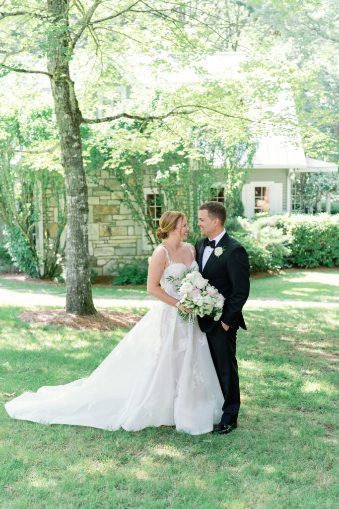 Bride and groom portraits in front of the cottage.