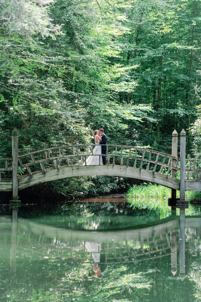 Bride and groom kiss on the bridge.