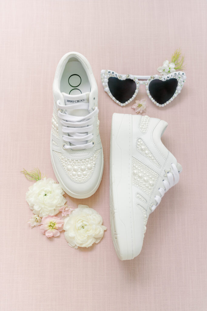 Jimmy Choo pearl design sneakers and white heart sunglasses. bride's second outfit details. 