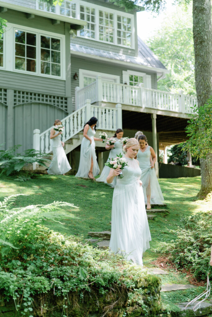 documentary style wedding photo of bridesmaids walking in highlands nc. 