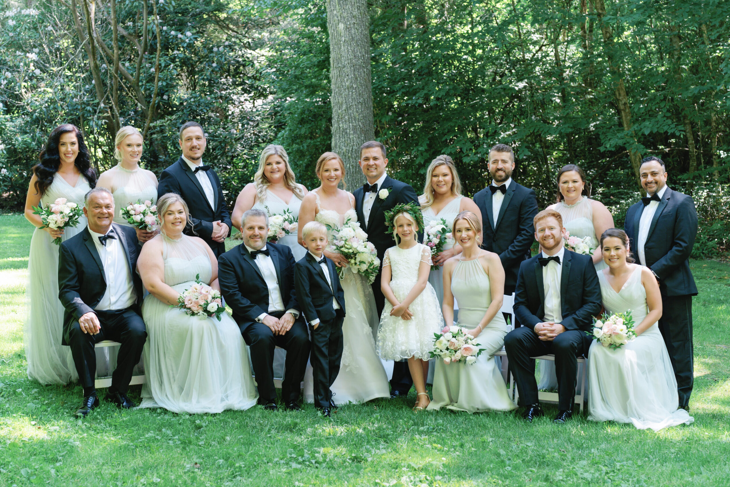 Formal seated photo of full bridal party. Summer destination wedding.